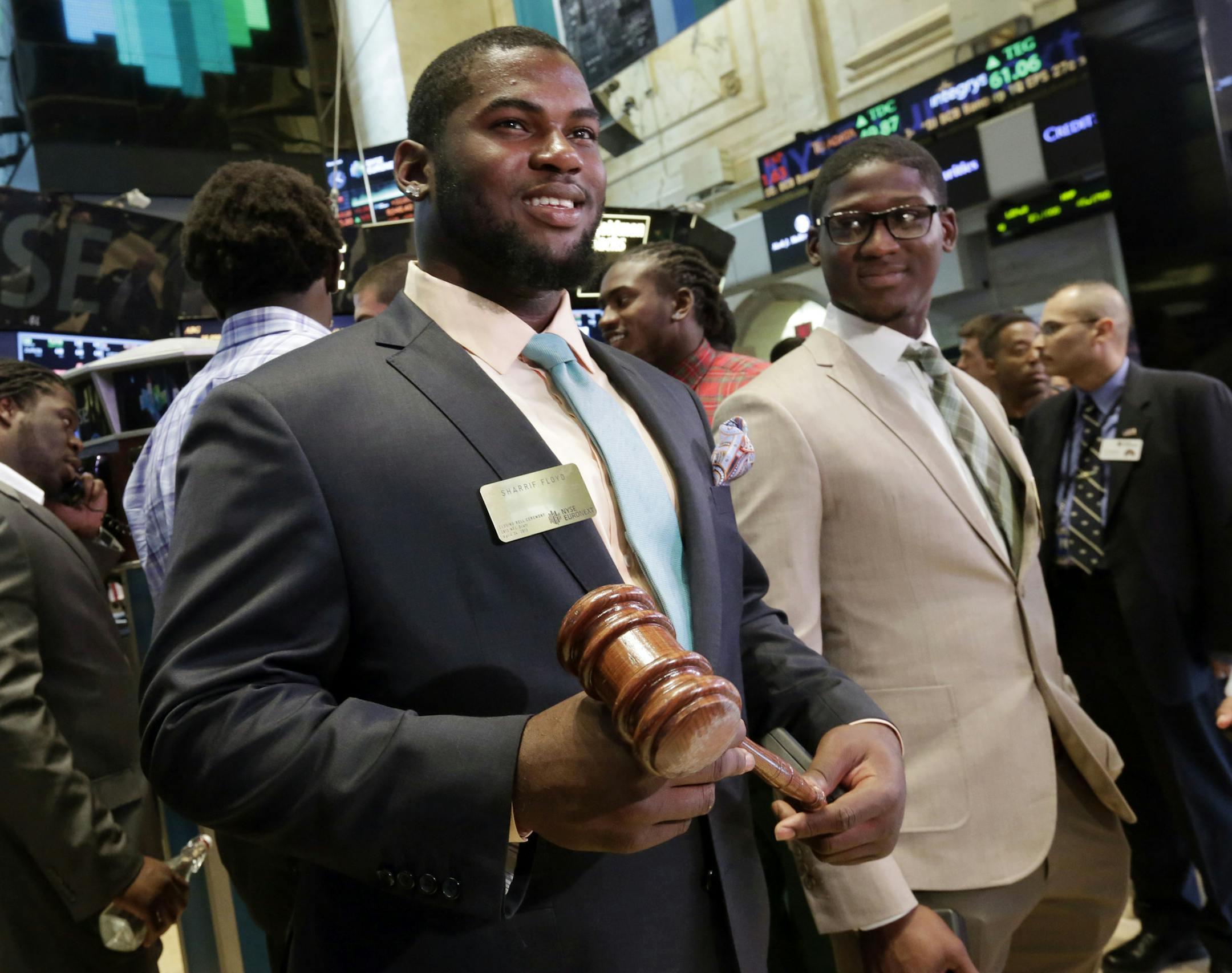 NFL draft prospects Sharrif Floyd, left, of Florida, and Xavier Rhodes, of Florida State, visit the trading floor of the New York Stock Exchange Wednesday, April 24, 2013. Sharrif holds the gavel he used to close the day's trading. (AP Photo/Richard Drew)