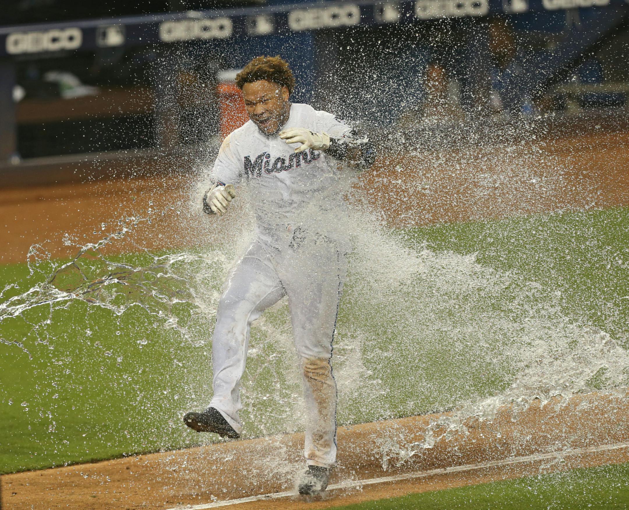 Miami left fielder Harold Ramirez is dumped with a cooler of water after hitting a walk-off home run against the Twins.