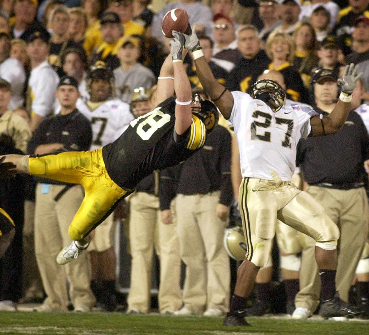 Iowa's Chad Greenway (18) breaks up a pass intended for Purdue's Brandon Jones, right, during the second half, Saturday, Nov. 6, 2004, in Iowa City, Iowa. Iowa won the game, 23-21. (AP Photo/Charlie Neibergall) ORG XMIT: IACN106,IACN106