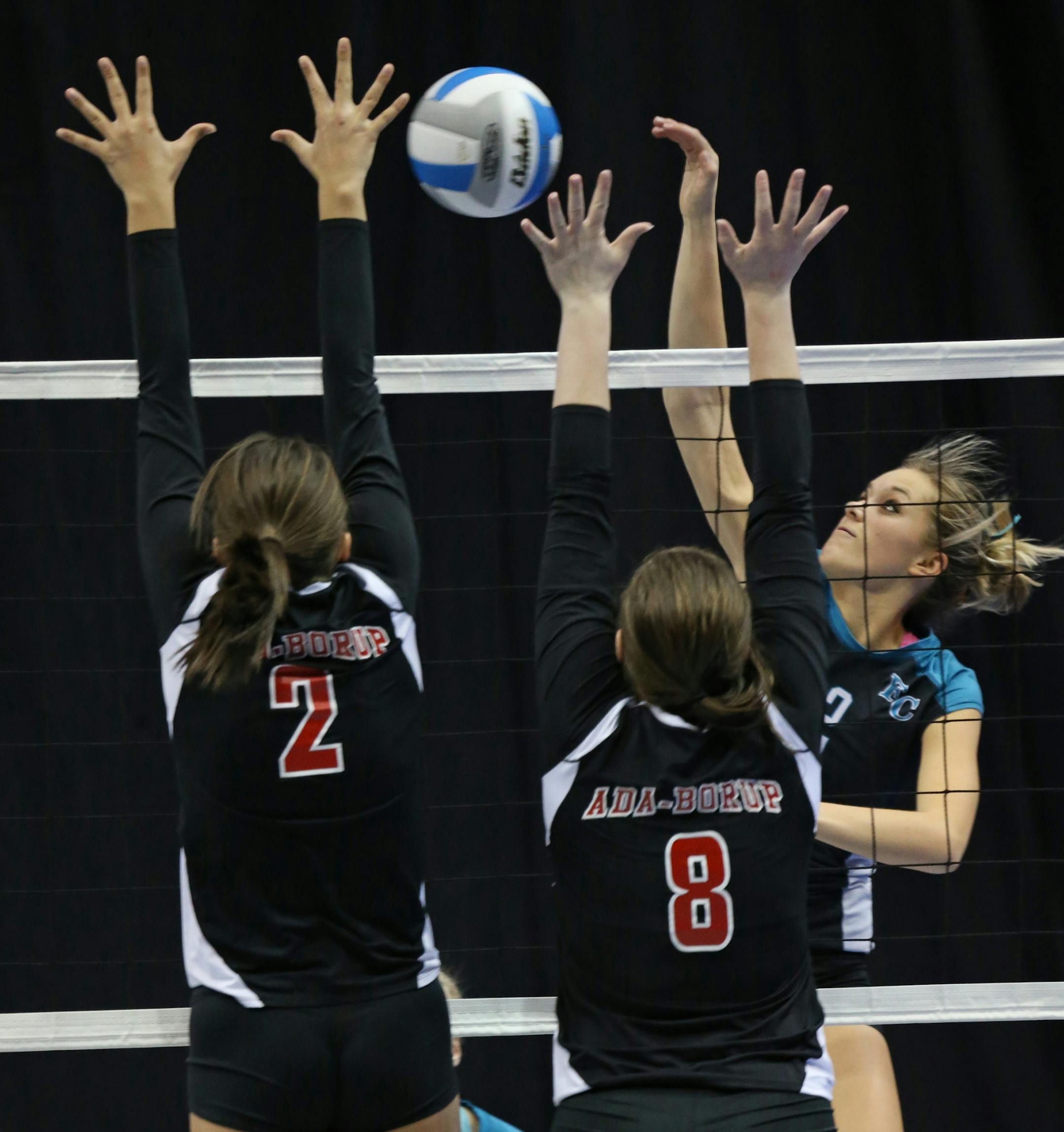 Minnesota State High School League Girls Volleyball State Tournament, 11/7/13, Xcel Energy Center. Class 1A state volleyball quarterfinals, Ada Borup vs. Fillmore Central. (left to right) Ada Borup's Miki Lee and Haley Boehier defended as Fillmore Central's Taylor Case spiked the ball.] Bruce Bisping/Star Tribune bbisping@startribune.com Miki Lee, Haley Boehier, Taylor Case/roster.