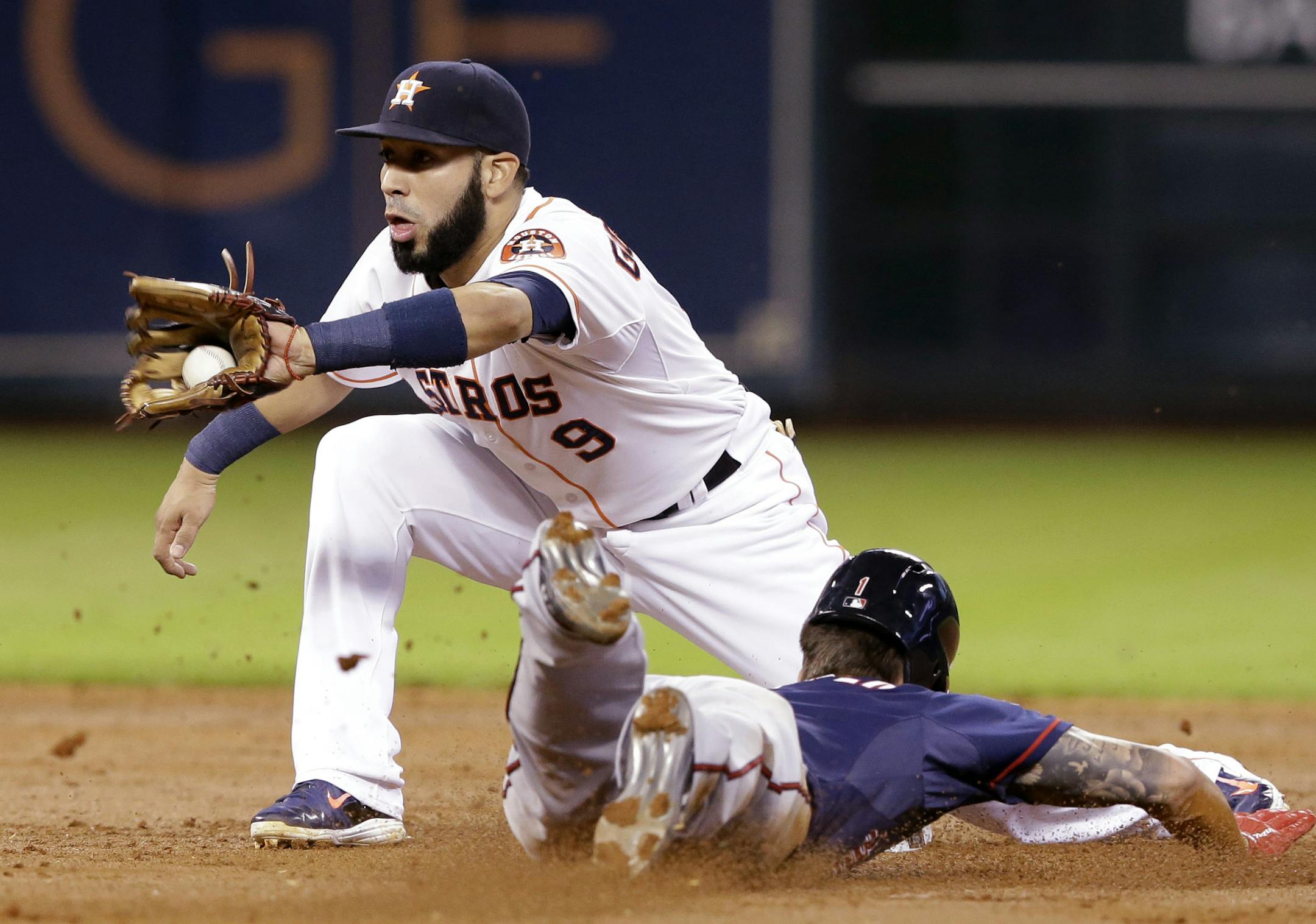 Minnesota Twins' Jordan Schafer, right, steals second base as Houston Astros shortstop Marwin Gonzalez (9) catches the ball in the third inning of a baseball game Tuesday, Aug. 12, 2014, in Houston. (AP Photo/Pat Sullivan) ORG XMIT: MIN2014081420281141