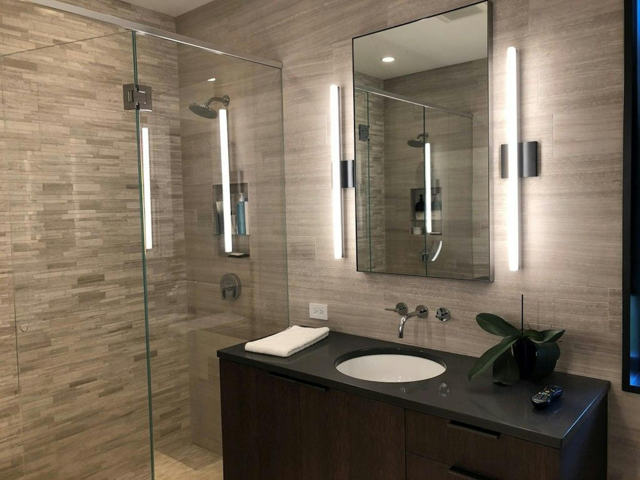 Owners' bathroom retreat features an over-sized tiled shower and double floating vanities.