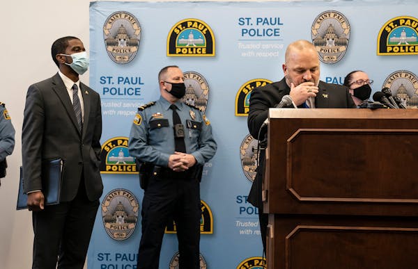 St. Paul Police Chief Todd Axtell, Mayor Melvin Carter and other officers stood at the podium as body camera footage played for the media on televisio
