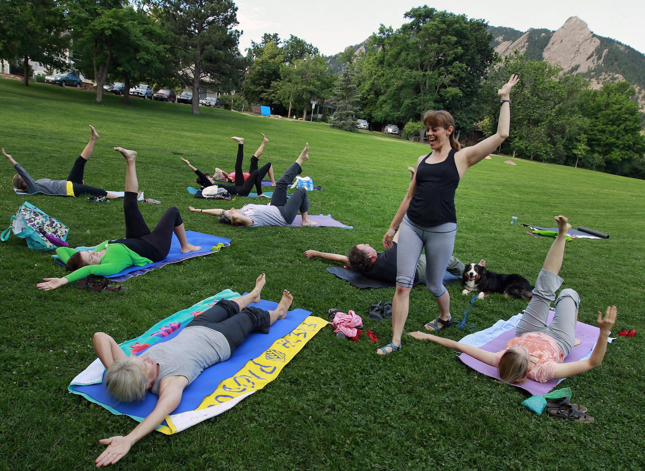 Robyn Spann leads an outdoor yoga class at Chautauqua Park in Boulder, Colorado, early Tuesday July 9, 2013. Colorado is ranked as one of the healthiest states in America, yet more than half the stateís residents are overweight or obese. On Thursday, Gov. John Hickenlooper plans to announce a statewide challenge using free online tools, giveaways and community support to encourage Coloradans to be more active, whether they walk, dance, garden, do yoga or something else. (AP Photo/Brennan Li