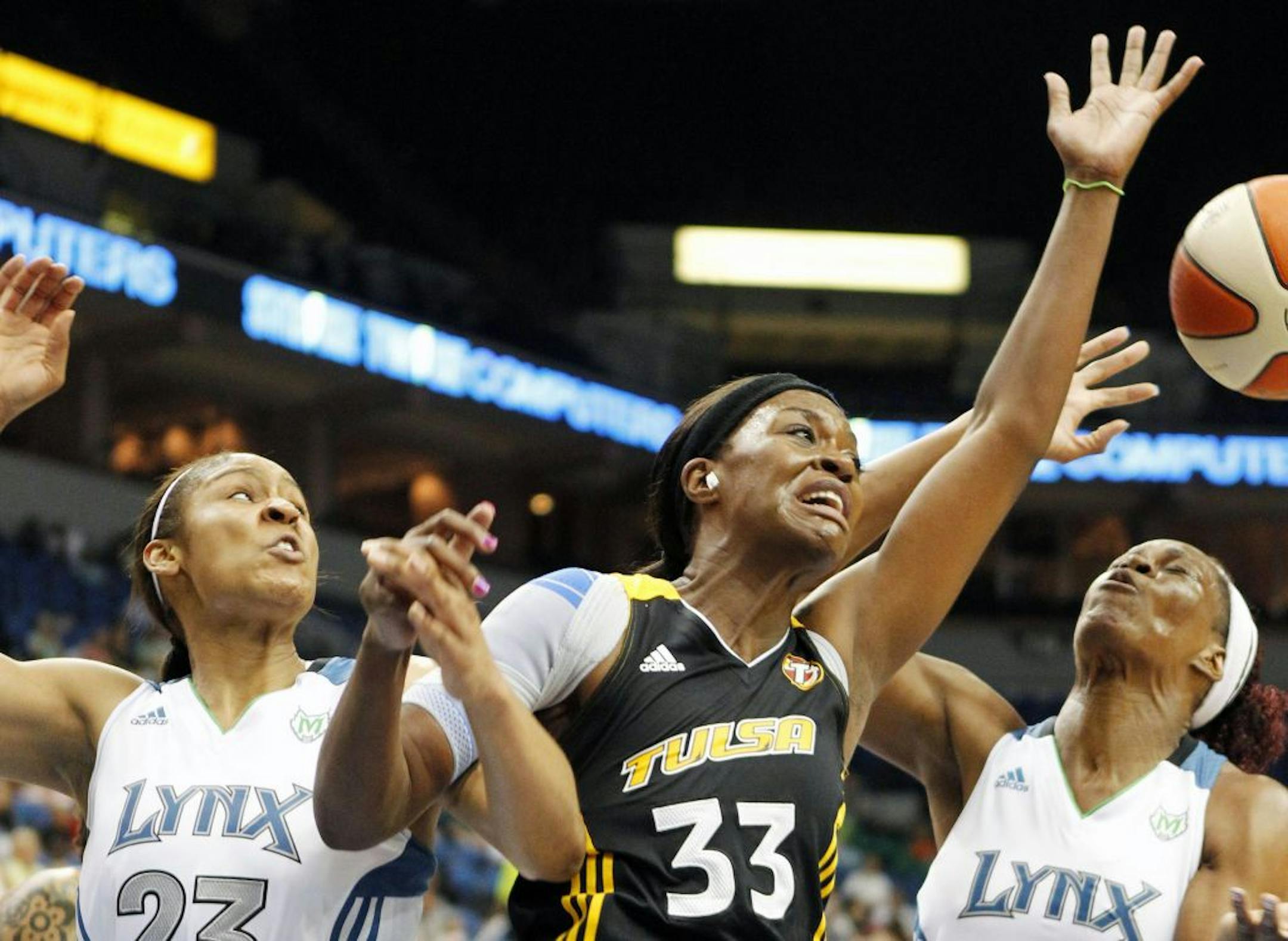 The Lynx tandem of Maya Moore (left) and Taj McWilliams-Franklin tried to box in Tulsa's Tiffany Jackson as they battled for a rebound in the Lynx's 75-65 victory over the Shock at Target Center on Tuesday.