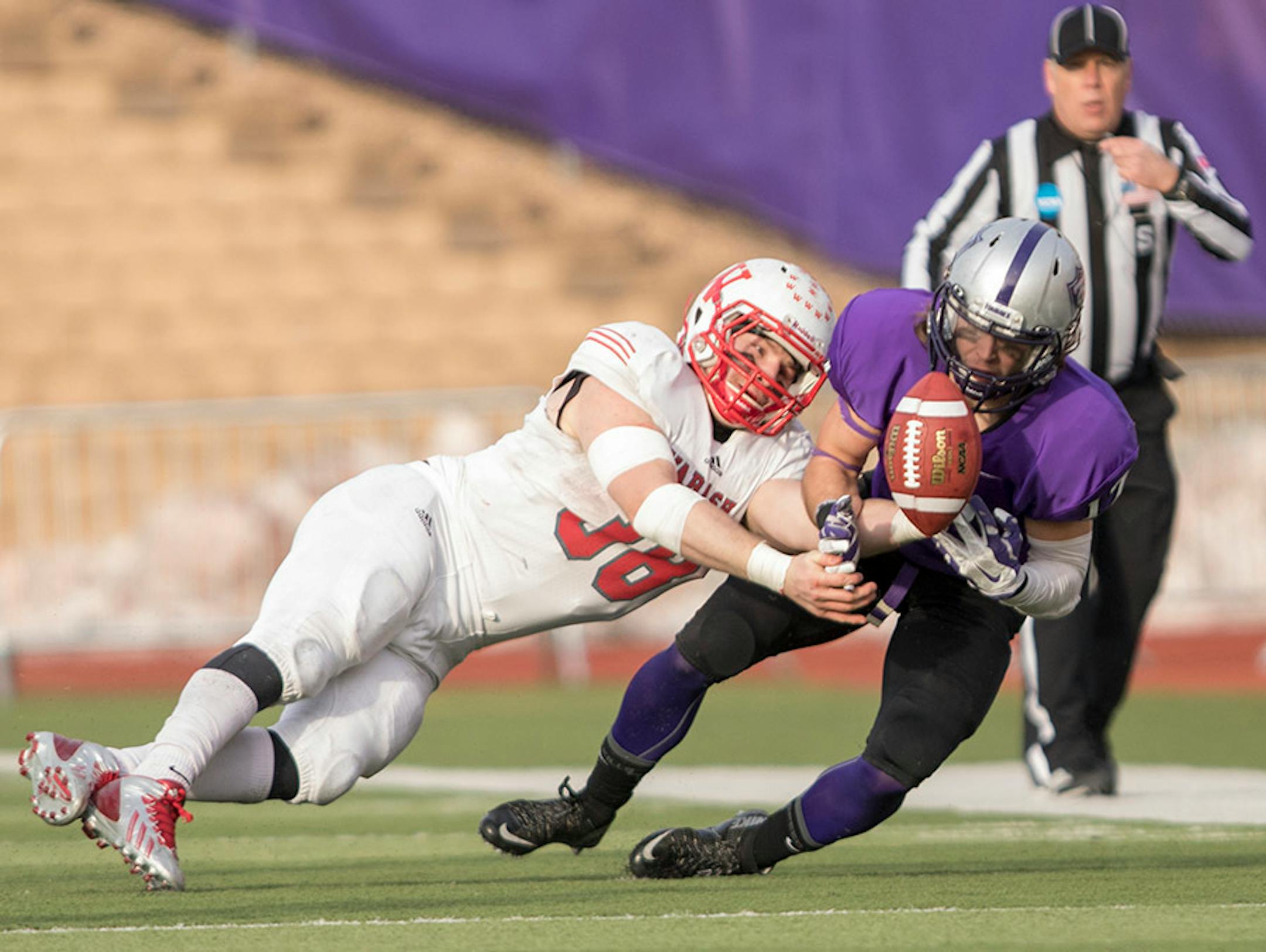 St. Thomas defensive back Trace Adams (17) breaks up a pass meant for Wabash RB Mason Zurek (38) as the University of St. Thomas Tommies hosted the Wabash College Little Giants on December 5, 2015.
