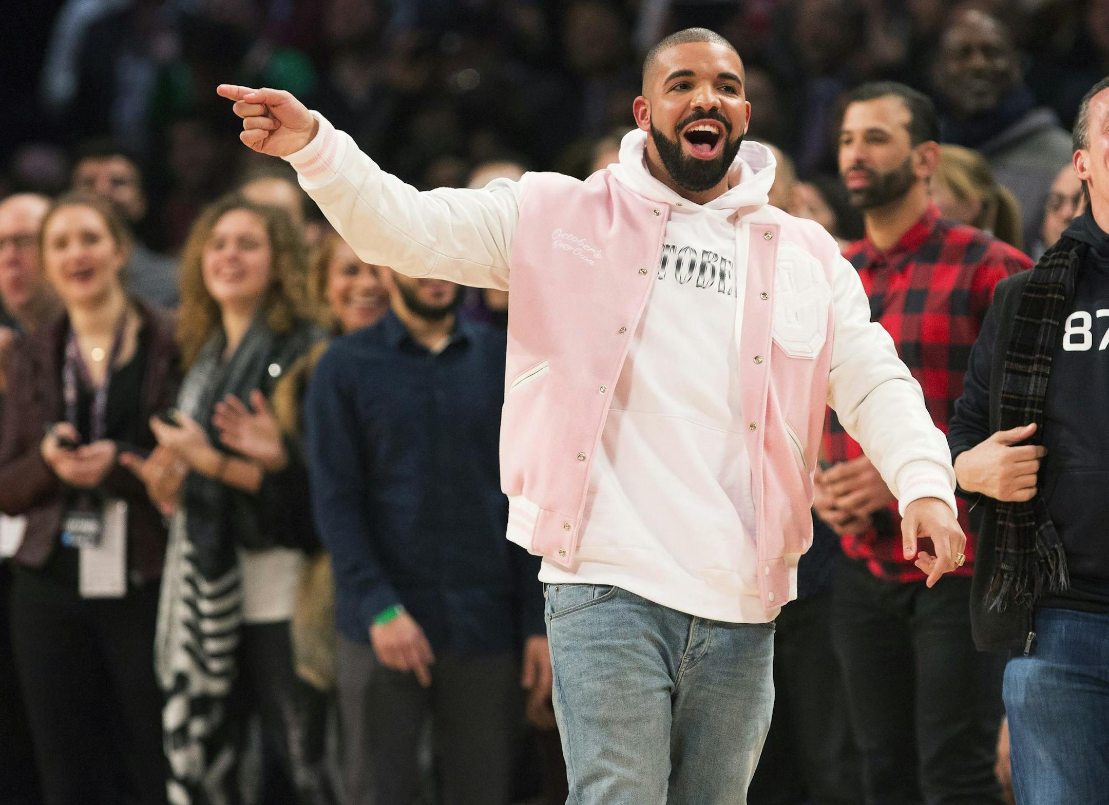 FILE In this Feb. 13, 2016 file photo, Rapper Drake, center, reacts on court during the skills competition at the NBA basketball All-Star weekend in Toronto. Celebrities abound as Drake strolls through the streets of New Orleans in his &#x201c;In My Feelings&#x201d; video. The social media challenge associated with the song is featured in the video, which was released Thursday, Aug. 2, 2018. (Mark Blinch/The Canadian Press via AP, File)