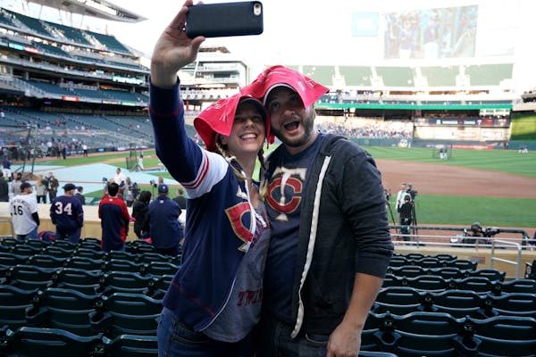 Stacey Green and Steve Frenzel take a selfie with Homer Hankies on their heads as fans prepared for Game 3.