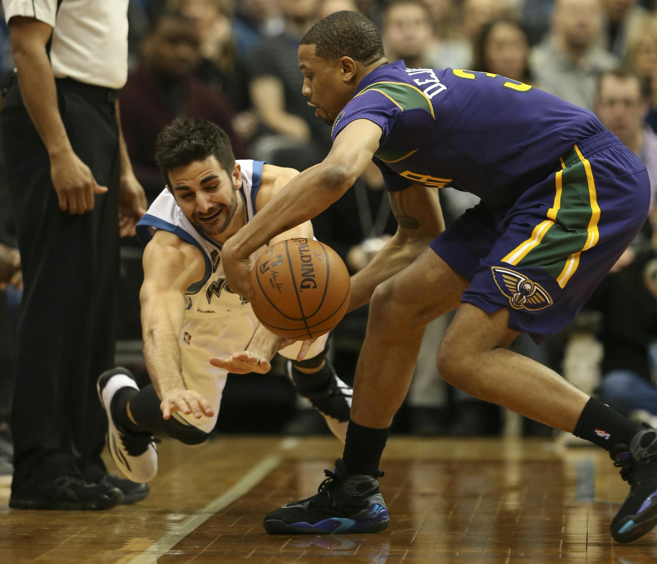 Timberwolves guard Ricky Rubio lunged for a loose ball in the first quarter Monday night, but Pelicans guard Bryce Dejean-Jones got to it first.