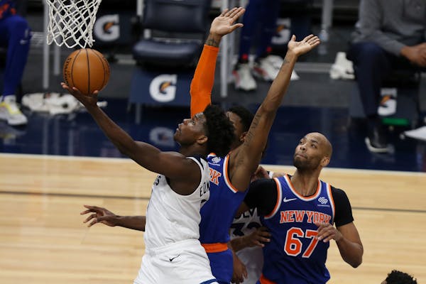 The Timberwolves' Anthony Edwards goes up to the basket past New York Knicks' RJ Barrett during the second half