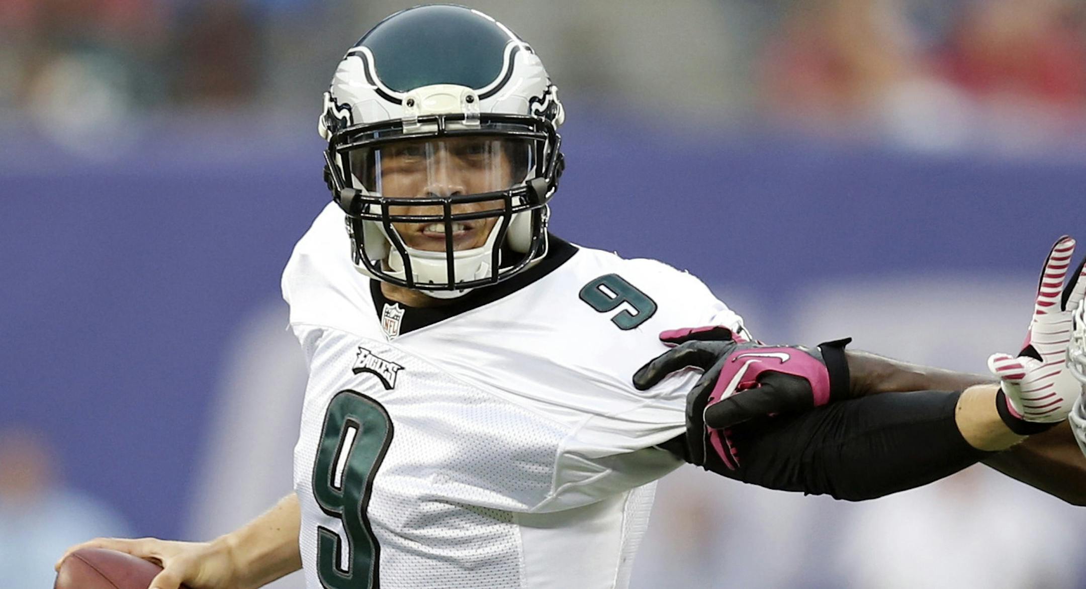 Philadelphia Eagles' Nick Foles (9) stiff-arms New York Giants' Mathias Kiwanuka (94) during the second half of an NFL football game on Sunday, Oct. 6, 2013, in East Rutherford, N.J. (AP Photo/Kathy Willens)