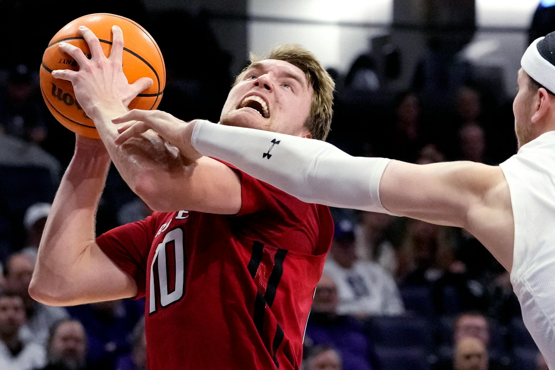 Rutgers guard Cam Spencer, left, drives to the basket against Northwestern forward Robbie Beran during the first half of an NCAA college basketball game in Evanston, Ill., Wednesday, Jan. 11, 2023. (AP Photo/Nam Y. Huh)