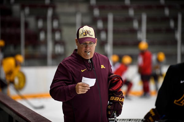 New Gophers men's hockey coach Bob Motzko looked through some notes during a recent practice at Ridder Arena.