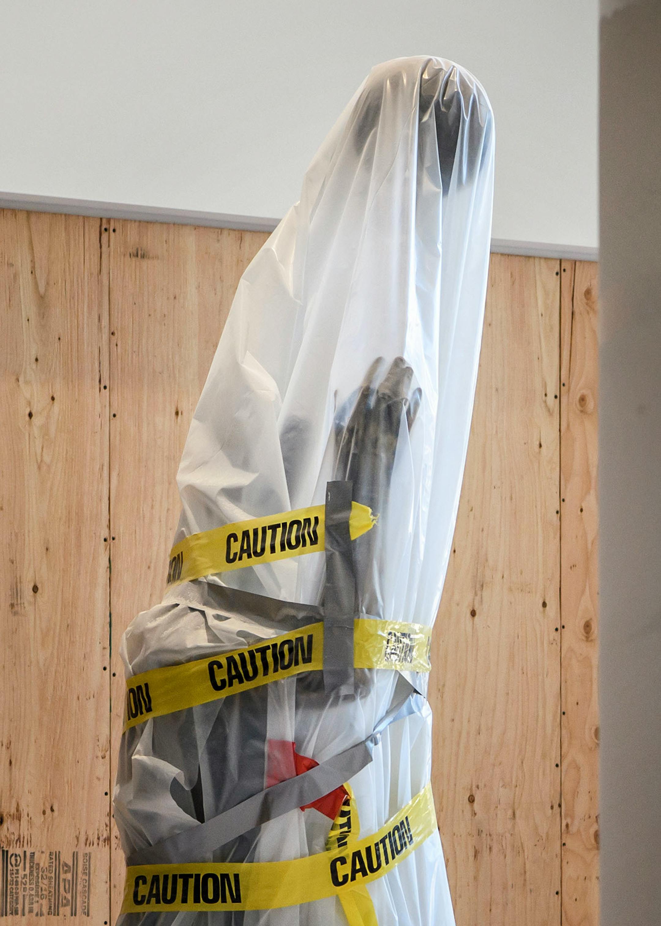 The George Mikan statue under protective wrapping as Target Center is renovated.