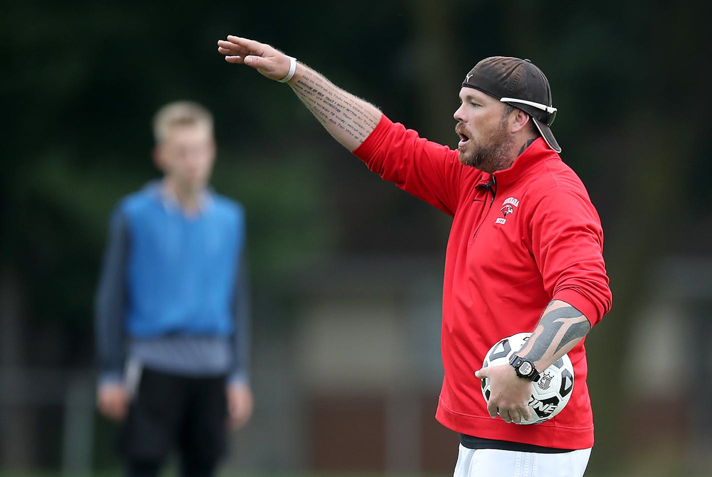 Minnehaha Academy boys' soccer coach Steven Barone directed practice last month. The team is playing under painful circumstances this fall, after an Aug. 2 explosion at Minnehaha severely injured assistant soccer coach Bryan Duffey. His right leg was amputated at the knee.