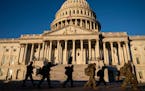 Members of the Army National Guard walk to board a bus after a shift at the Capitol Building in Washington, Jan. 10, 2021.