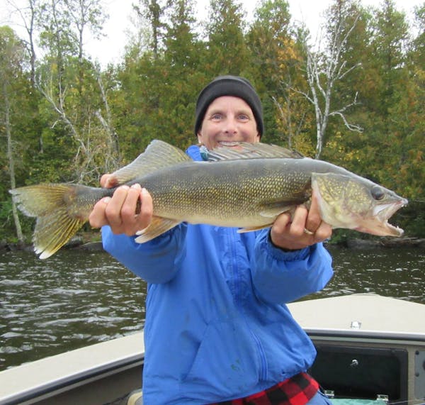 Lesa Woitas of Ellsworth, Wis., holding a monster walleye she caught on Lake Vermilion during a Women Anglers of Minnesota fall trip.