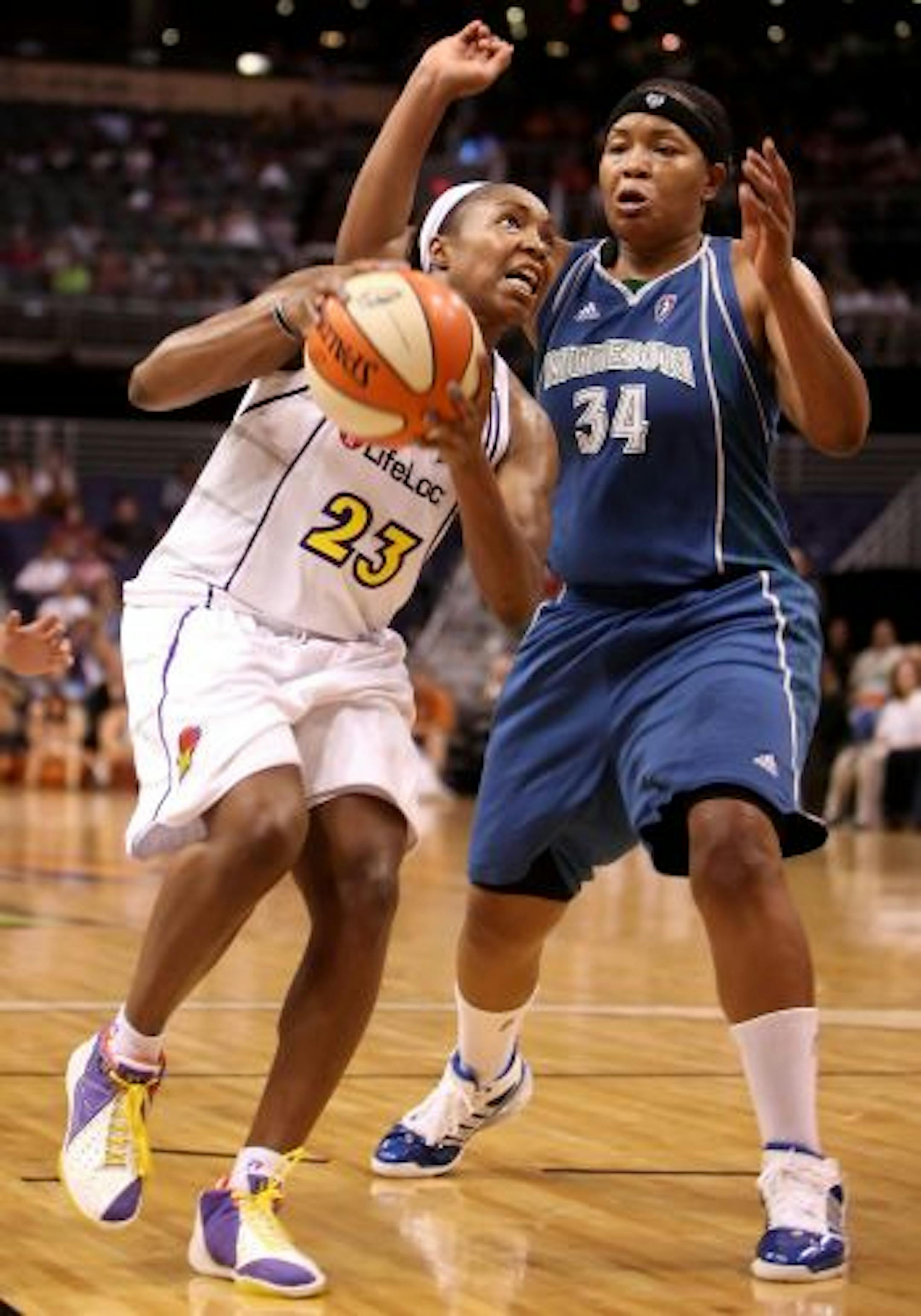 PHOENIX - JULY 22: Cappie Pondexter #23 of the Phoenix Mercury drives with the ball past Tasha Humphrey #34 of the Minnesota Lynx during the WNBA game at US Airways Center on July 22, 2009 in Phoenix, Arizona. The Lynx defeated the Mercury 99-86.