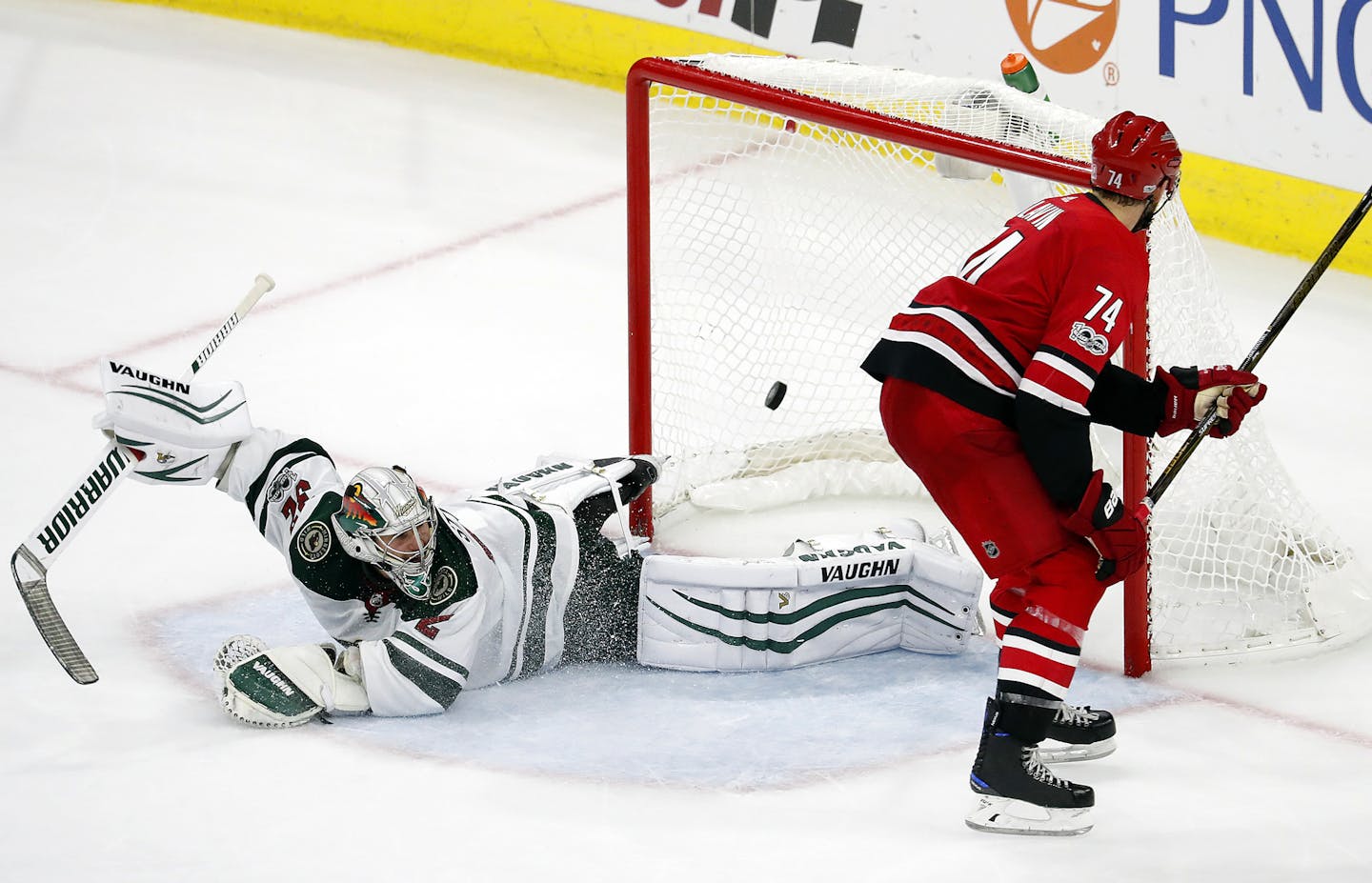 Carolina Hurricanes' Jaccob Slavin (74) shoots the puck past Minnesota Wild goalie Alex Stalock (32) to win the shootout during an NHL hockey game, Saturday, Oct. 7, 2017, in Raleigh, N.C. (AP Photo/Karl B DeBlaker)