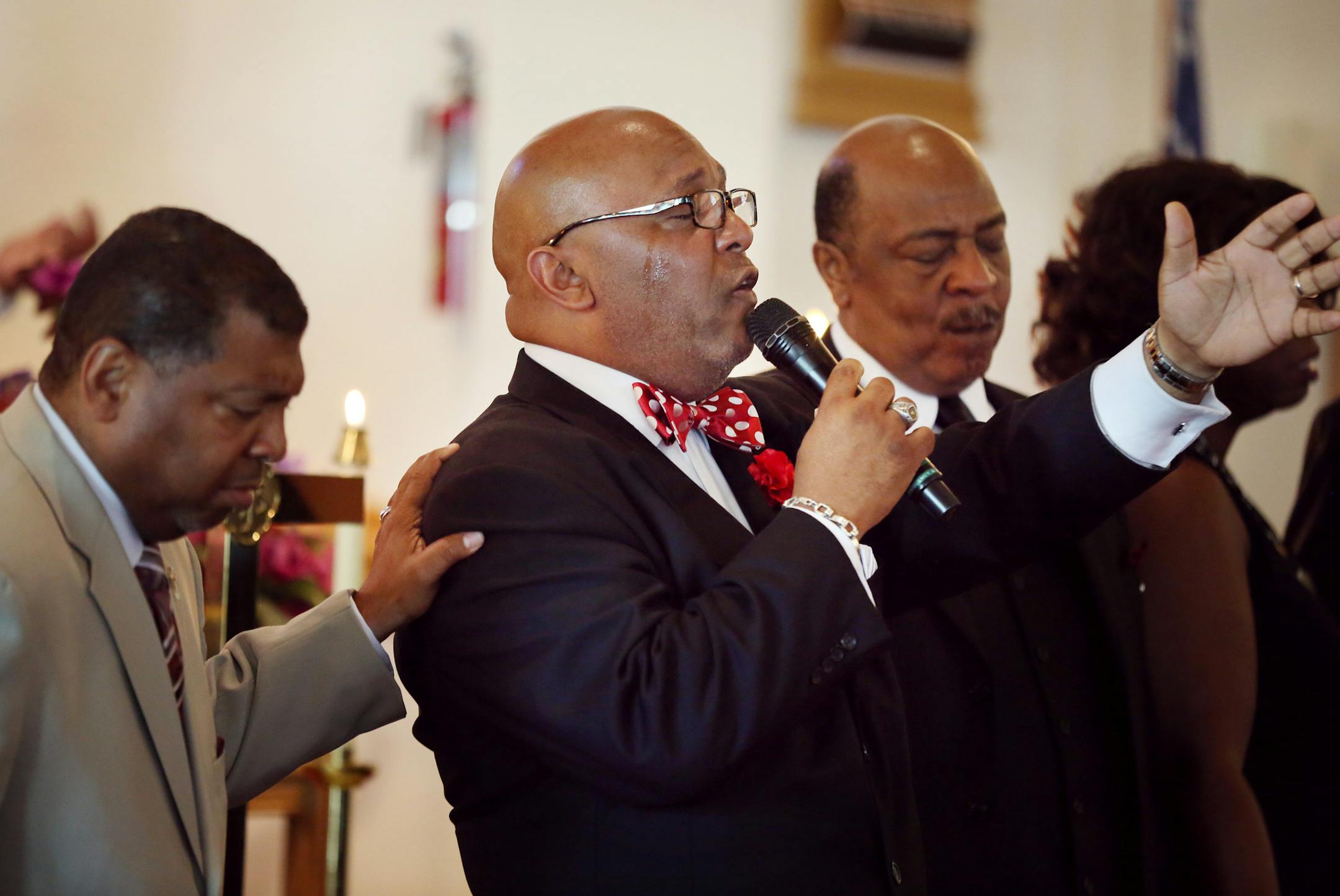 Pastor Nazim B Fakir (center) said a prayer for the 9 people killed last week in Charleston during church service at ST. Peter's AME Sunday June 21, 2015 in Minneapolis, MN. Nazim B Fakir Senior Pastor at the church said special prayers form the 9 people were murdered last Wednesday night in Charleston, South Carolina. ] Jerry Holt/ Jerry.Holt@Startribune.com