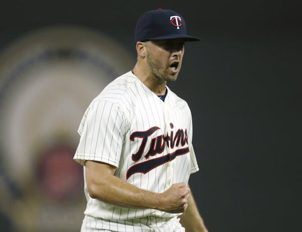 Minnesota Twins pitcher Brandon Kintzler pups his fist after striking out Miami Marlins&#x2019; Giancarlo Stanton for the final out of a baseball game