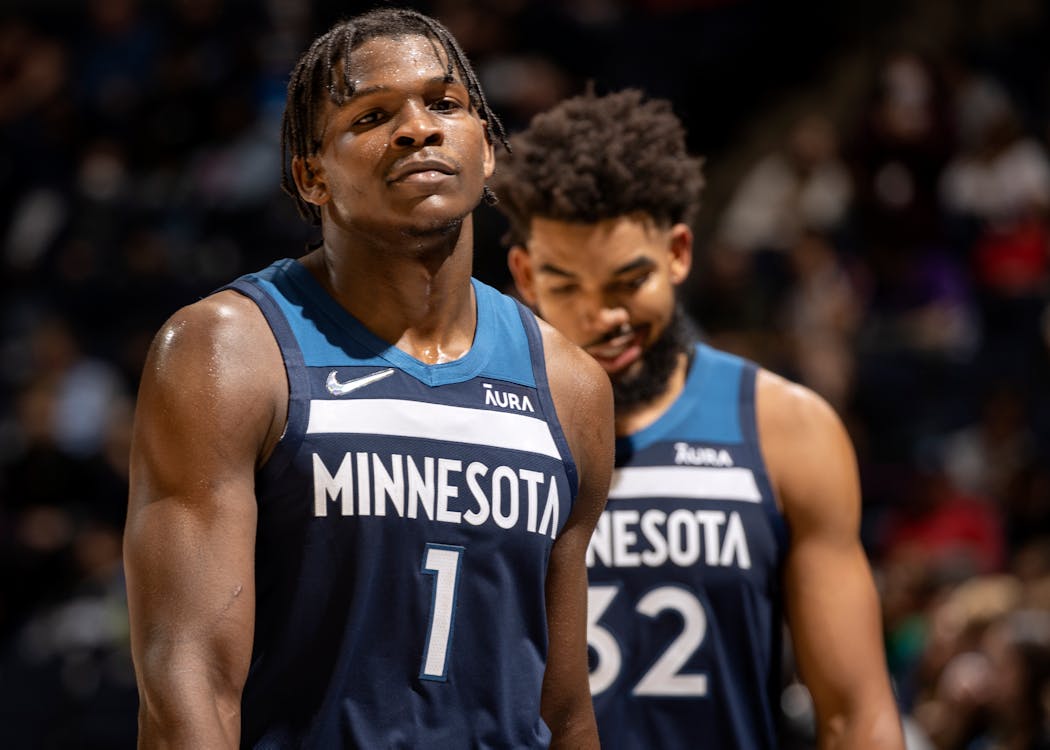 Anthony Edwards, left, is a brand ambassador for Aura, a digital protection company that recently struck a marketing deal to put its name on the Timberwolves jersey over the next several years. 