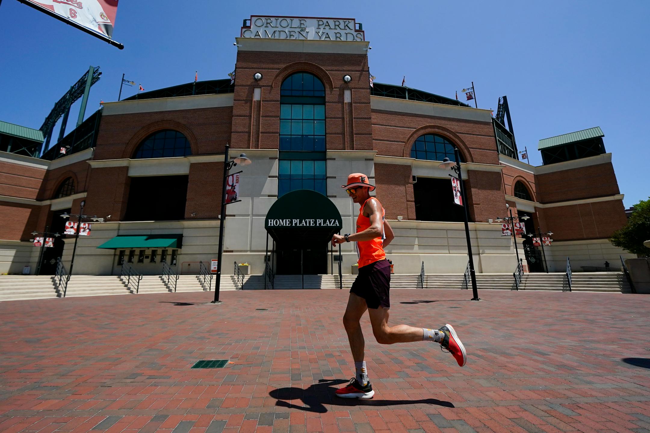 Graham Peck celebrates his 34th birthdate by running 34 laps around Oriole Park at Camden Yards ahead of a baseball game between the Baltimore Orioles and the Cleveland Guardians, Wednesday, May 31, 2023, in Baltimore. According to Peck, the laps are roughly a kilometer long. (AP Photo/Julio Cortez)
