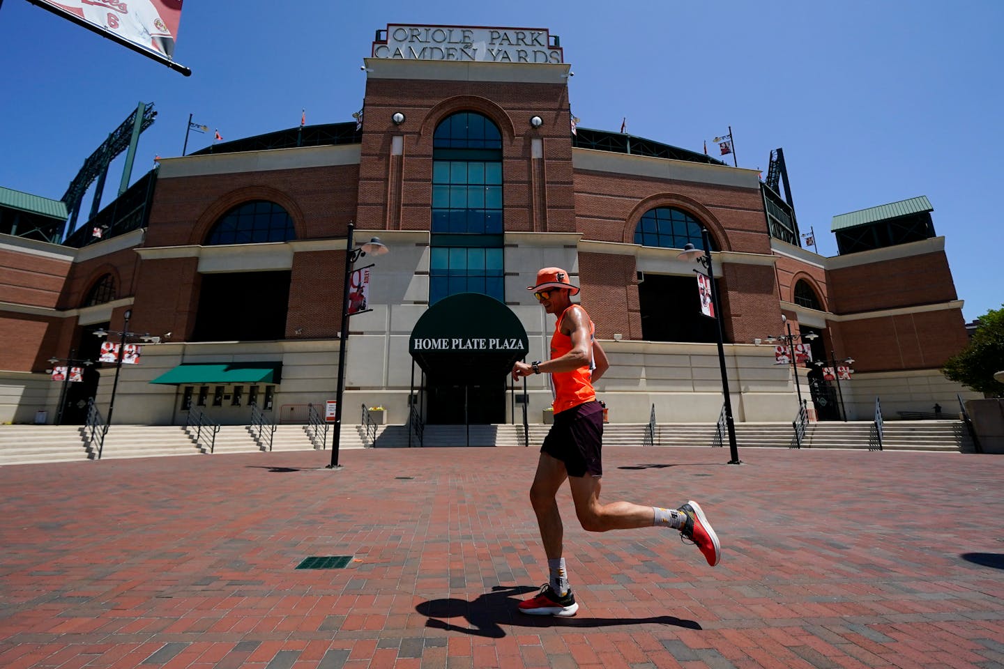 Graham Peck celebrates his 34th birthdate by running 34 laps around Oriole Park at Camden Yards ahead of a baseball game between the Baltimore Orioles and the Cleveland Guardians, Wednesday, May 31, 2023, in Baltimore. According to Peck, the laps are roughly a kilometer long. (AP Photo/Julio Cortez)