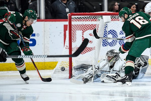 Jonathan Quick was able to stop a scoring attempt by the Wild's Mikael Granlund (64) and Jason Zucker (16) in the second period