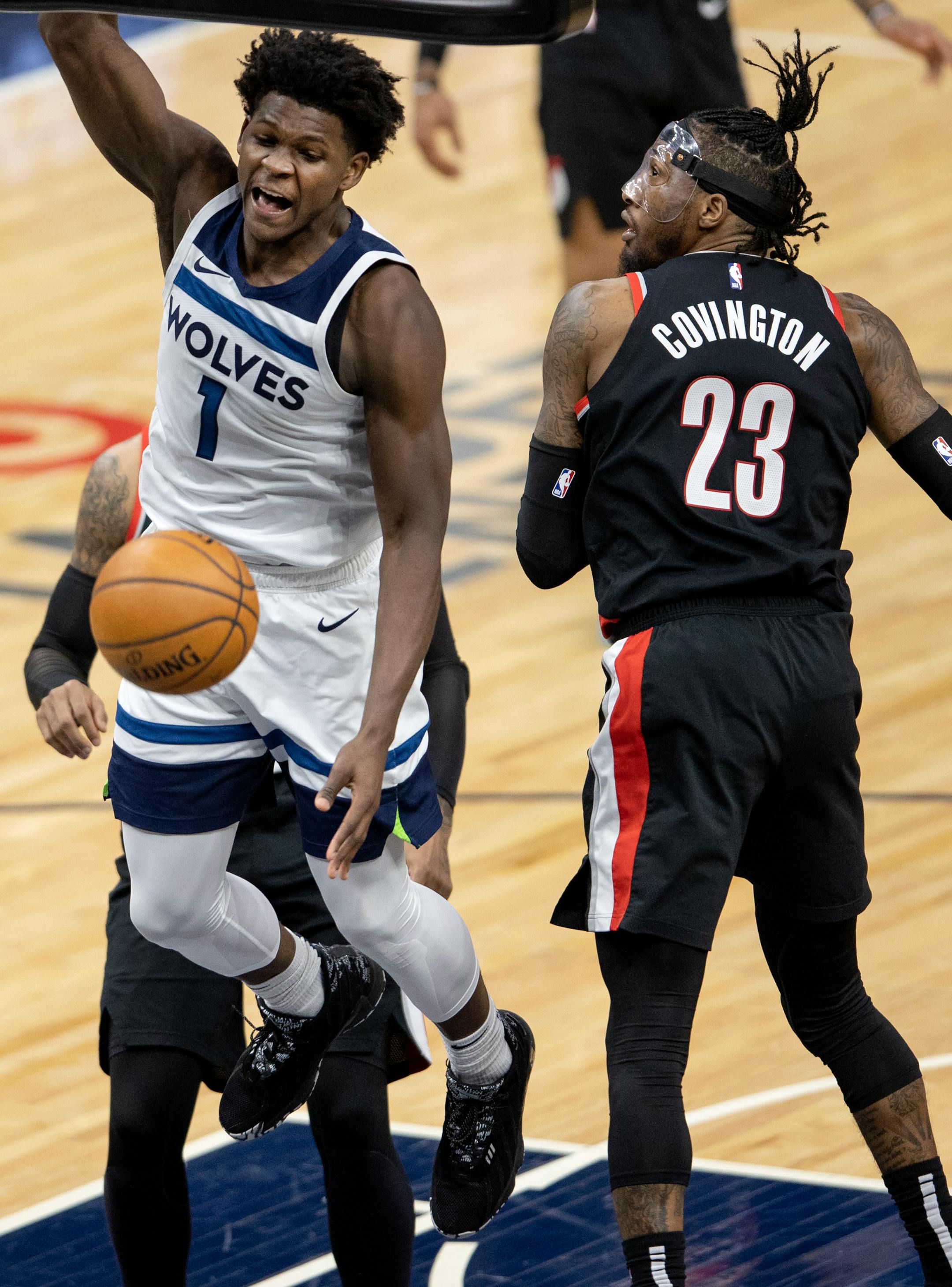 Anthony Edwards (1) ) of the Minnesota Timberwolves dunked the ball past Robert Covington (23) of the Portland Trailblazers in the fourth quarter.