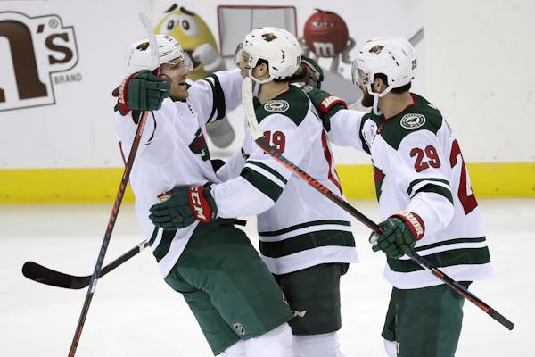 Minnesota Wild players, from left, Marcus Foligno, Luke Kunin and Greg Pateryn celebrate Kunin's goal against the New Jersey Devils during the third p