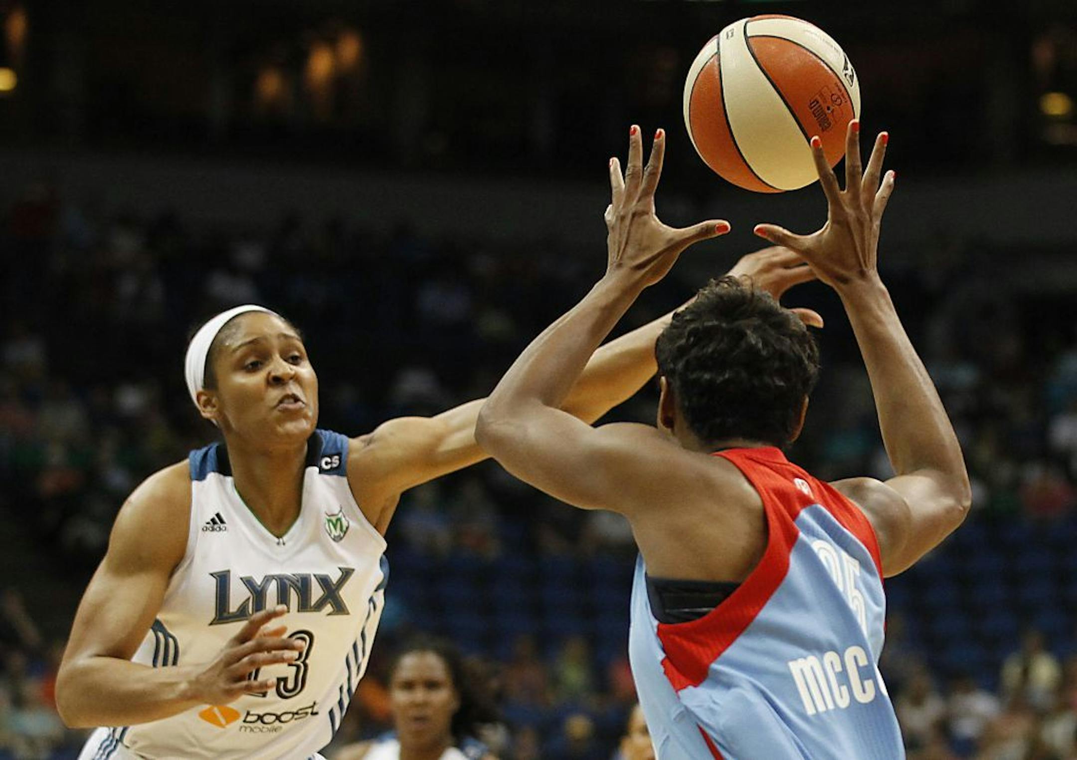 Minnesota Lynx forward Maya Moore tries to block a pass from Atlanta Dream guard Angel McCoughtry in the first half of a WNBA game Tuesday, July 9, 2013, in Minneapolis.