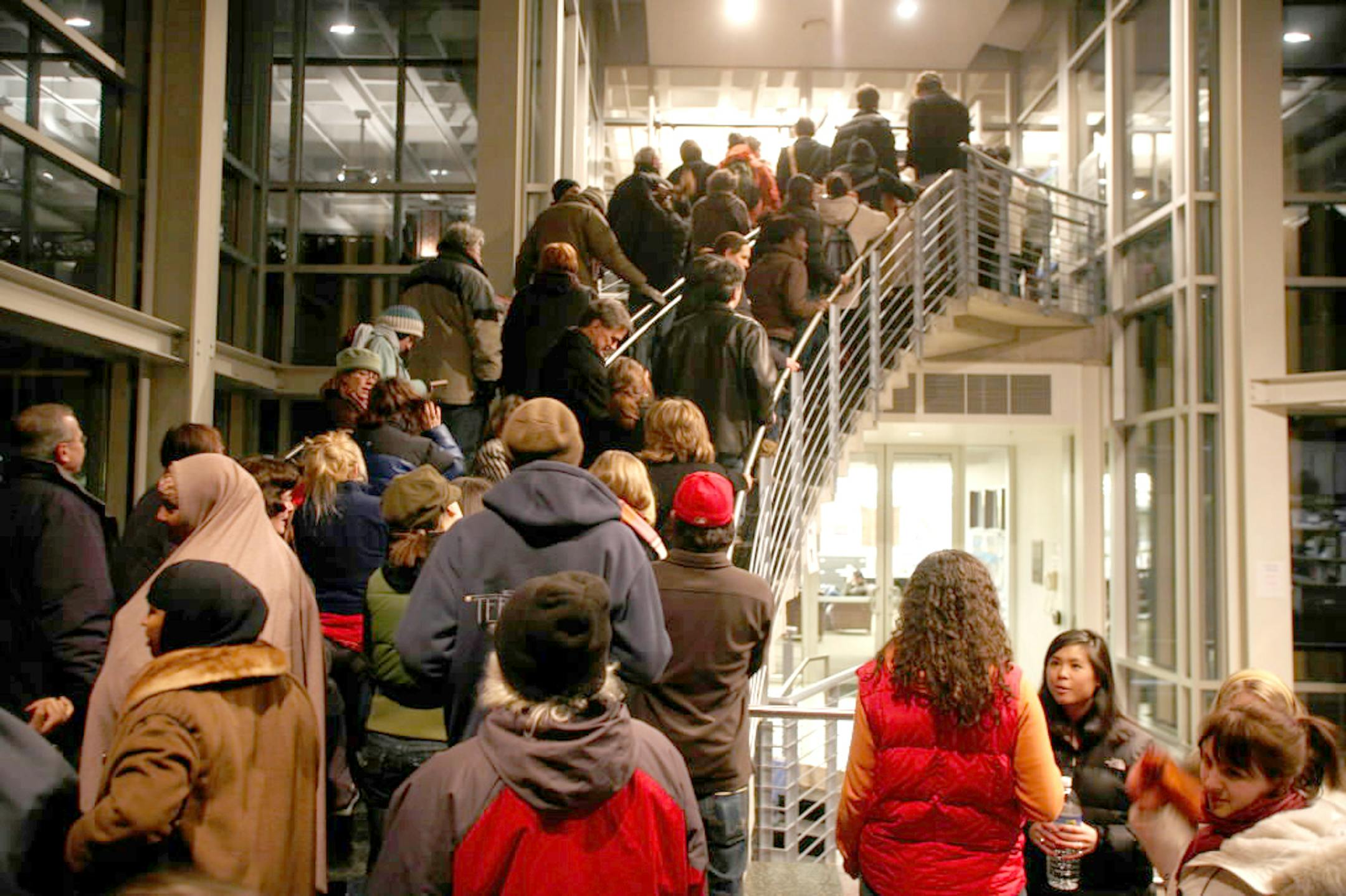 Caucus goers waited in line to get into the St. Paul DFL Ward 3, Precinct 7 event. The line continued outside the building, and the caucus was delayed to allow more people time to sign in.