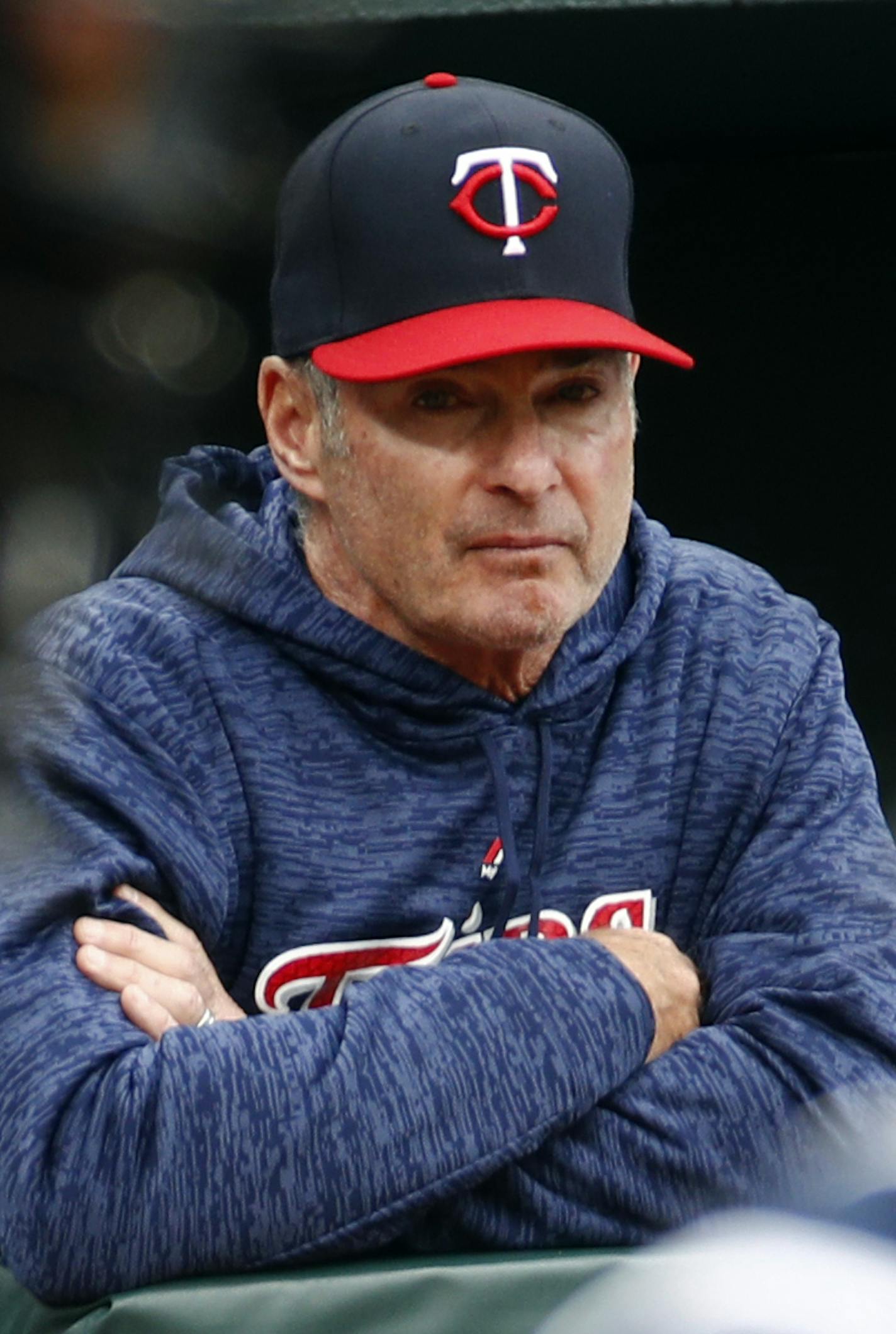 Minnesota Twins manager Paul Molitor is seen past home plate umpire Marty Foster, front left, and Twins catcher Mitch Garver as he watches the seventh inning of a baseball game against the Baltimore Orioles, Sunday, April 1, 2018, in Baltimore. (AP Photo/Patrick Semansky)