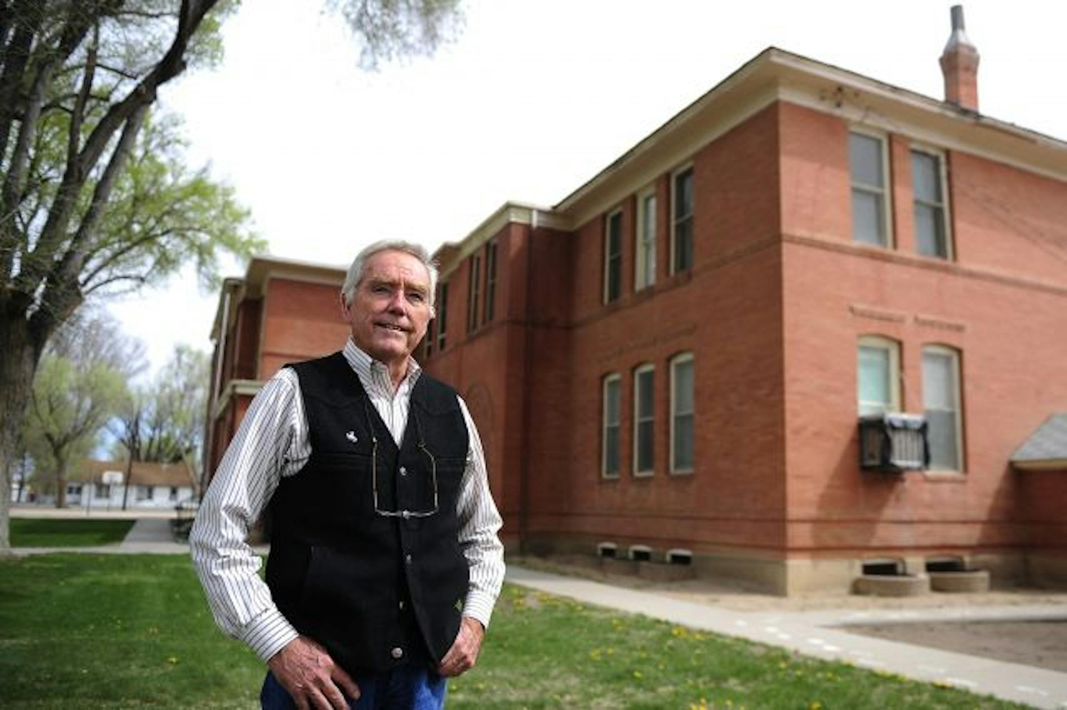 Wayne Snider, a former corporate executive who is now Fowler, Colo.'s town manager, stood near a former school that'll soon house city administration offices, the library and the Police Department. The 105-year-old building will be run by solar power and use geothermal exchange for heating and cooling.