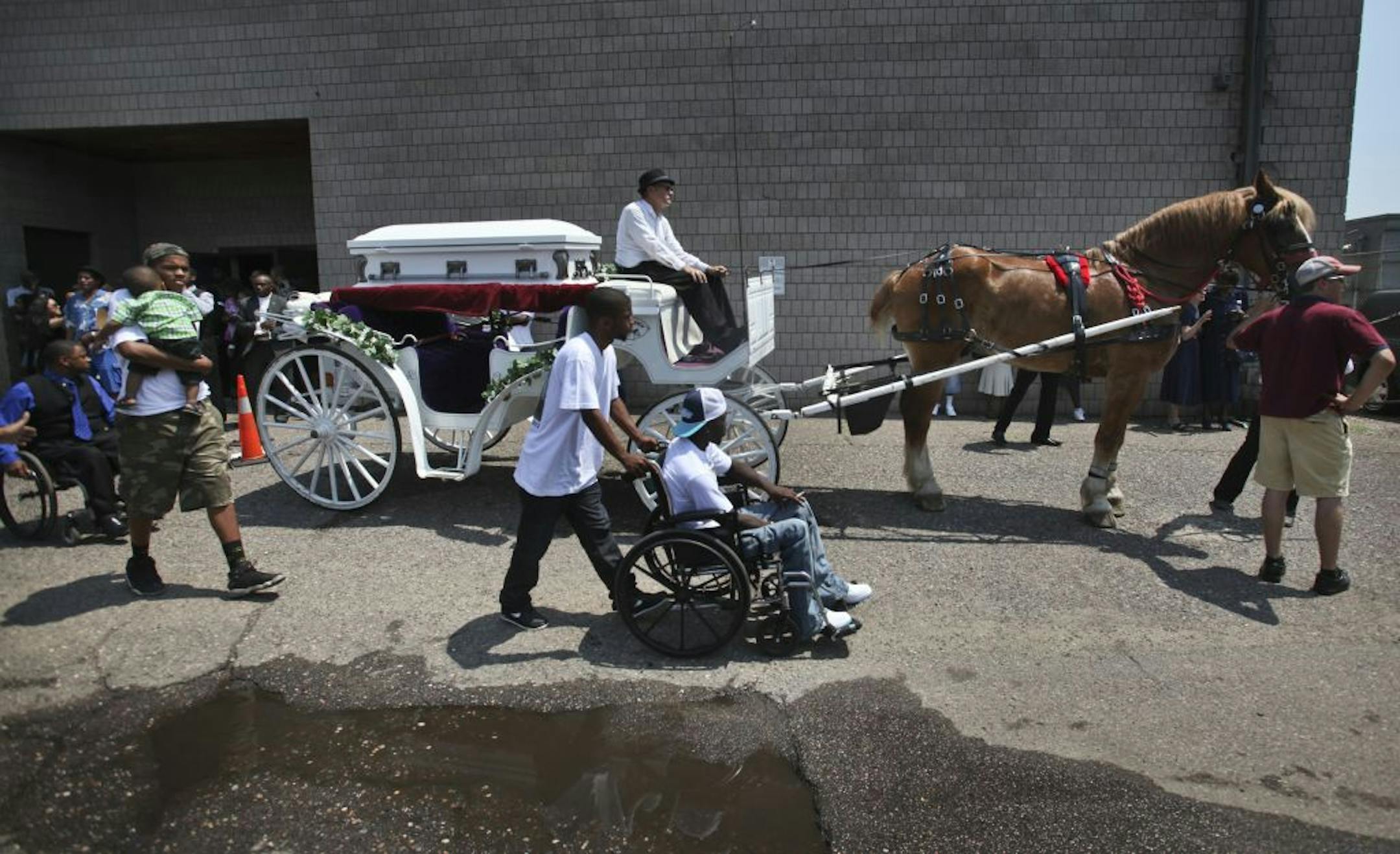Mourners passed the horse-drawn carriage bearing Nizzel's coffin before it pulled away. At the end of the service for the boy, Bishop Richard D. Howell Jr. called for an end to the violence. "We're going to make it work," he said. "Let's call it the Nezzel pledge. We're going to get along today."
