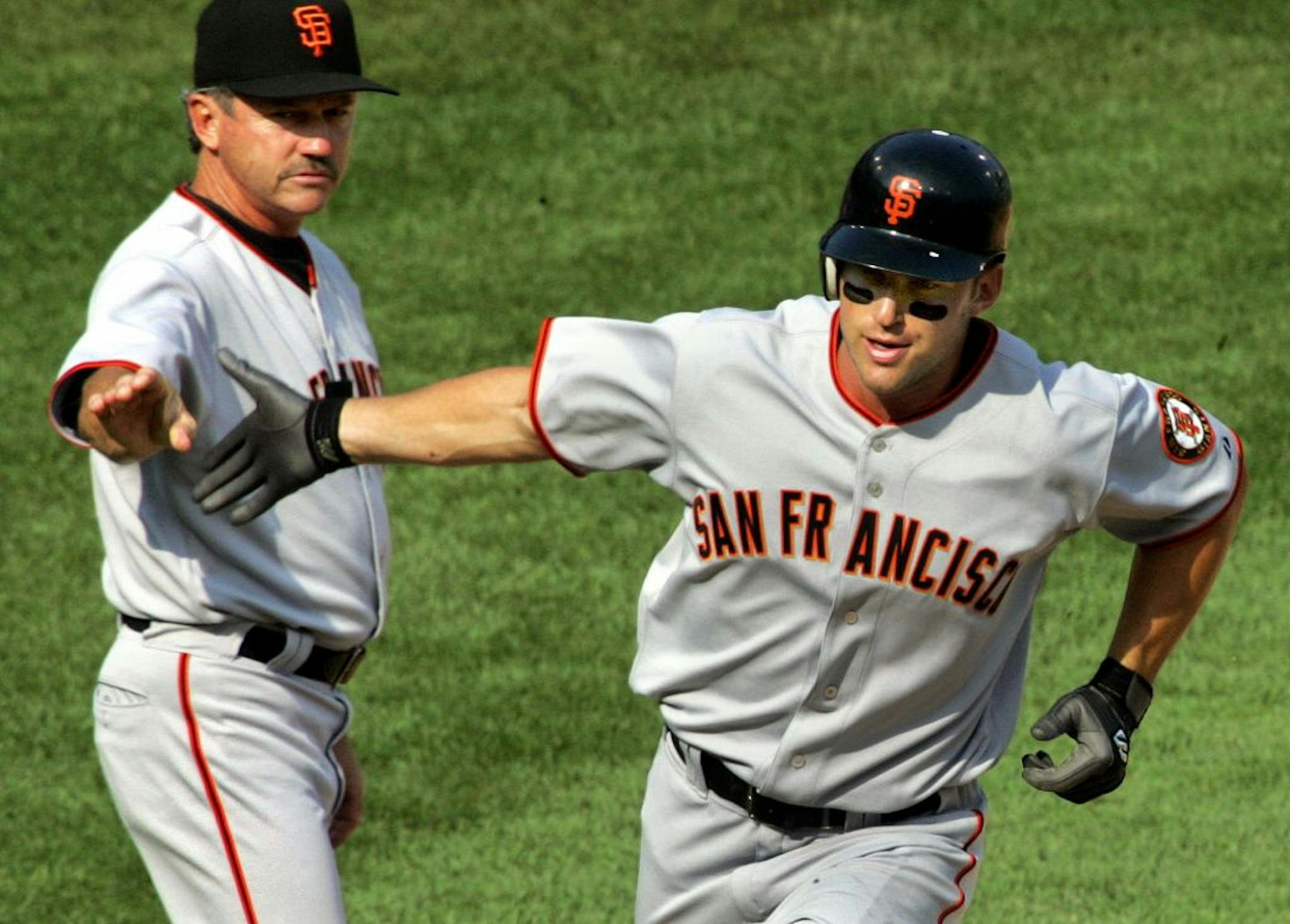 San Francisco Giants' Todd Linden, right, rounds third to greetings from coach Gene Glynn after hitting a solo home run off Pittsburgh Pirates reliever Matt Capps in the eighth inning of baseball action Sunday, July 30, 2006, at Pittsburgh.