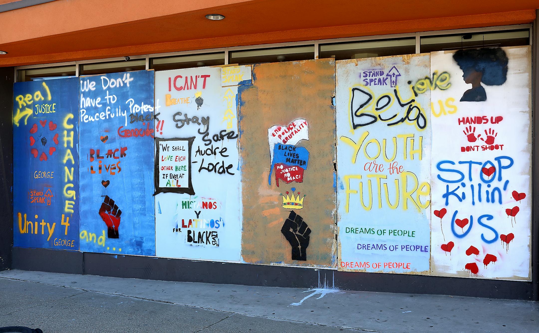 Murals outside of the Cookie Cart at 1119 W. Broadway in north Minneapolis call for justice and solidarity.