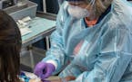 OptumLabs nurse Kristeen Shursen prepared to administer an infusion of antibodies at the site in Minnetonka.