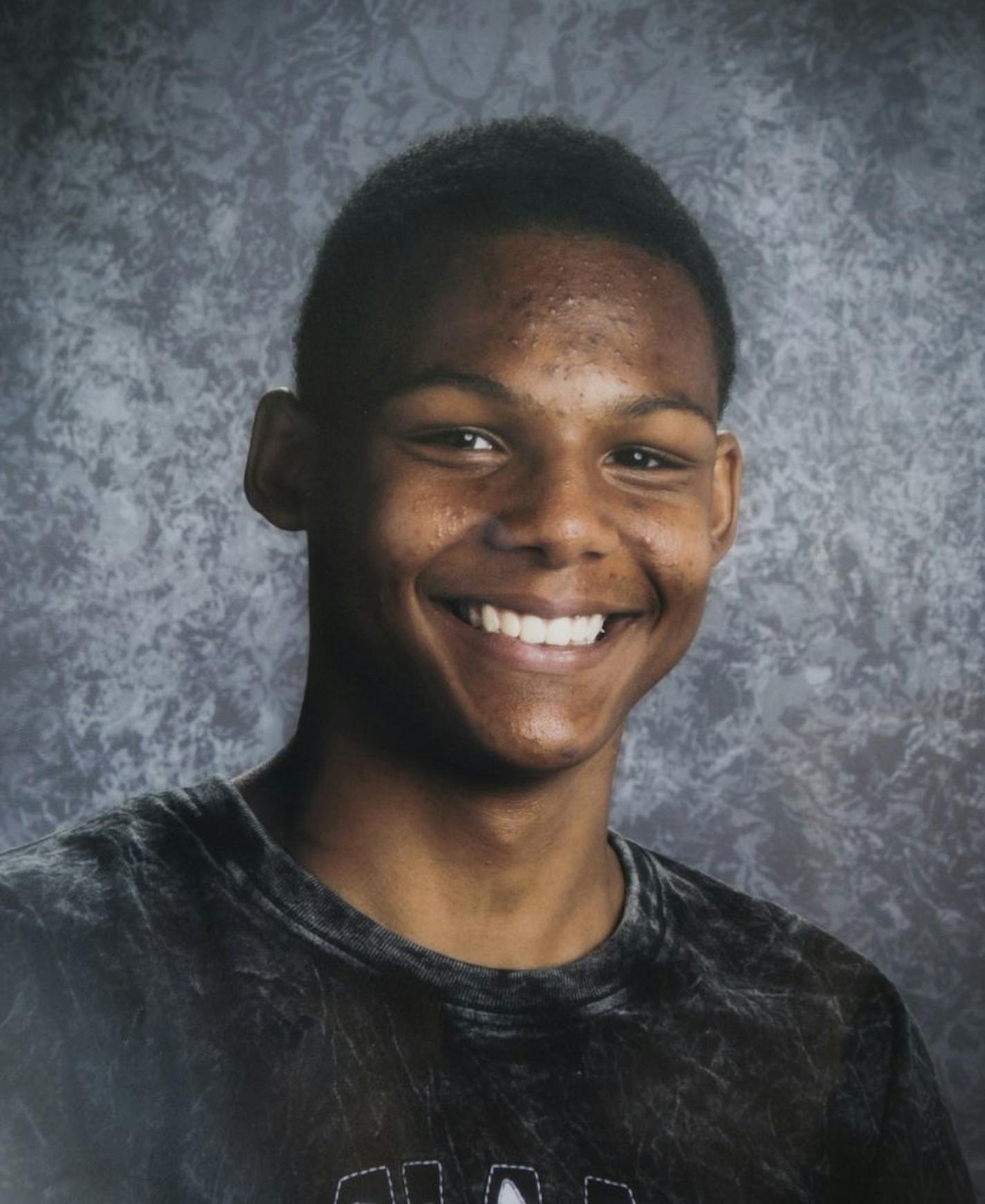 A school picture of Sha-Kym Adams photographed at a memorial on Thursday, August 7, 2014 at the East beach at Lake Nokomis where 15-year-old Sha-Kym Adams drowned yesterday while at the beach with his friends.