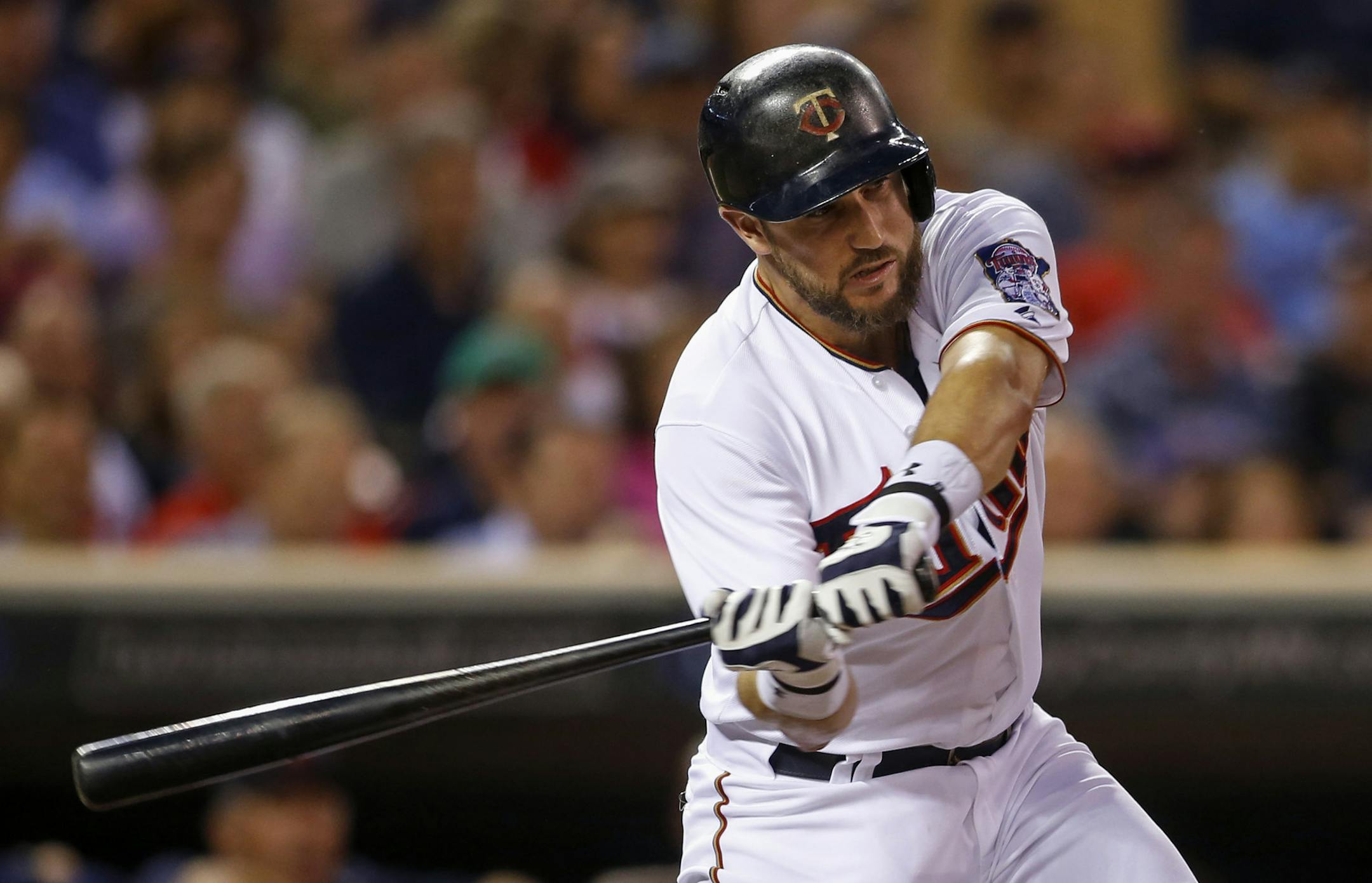 Minnesota Twins third baseman Trevor Plouffe (24) hits a two run double against the Detroit Tigers in the first inning of a baseball game, Monday, Sept. 14, 2015, in Minneapolis. (AP Photo/Bruce Kluckhohn)