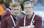 University of Minnesota President Eric Kaler, center, and Director of Athletics Mark Coyle, left, watched the game from the sidelines as Minnesota too