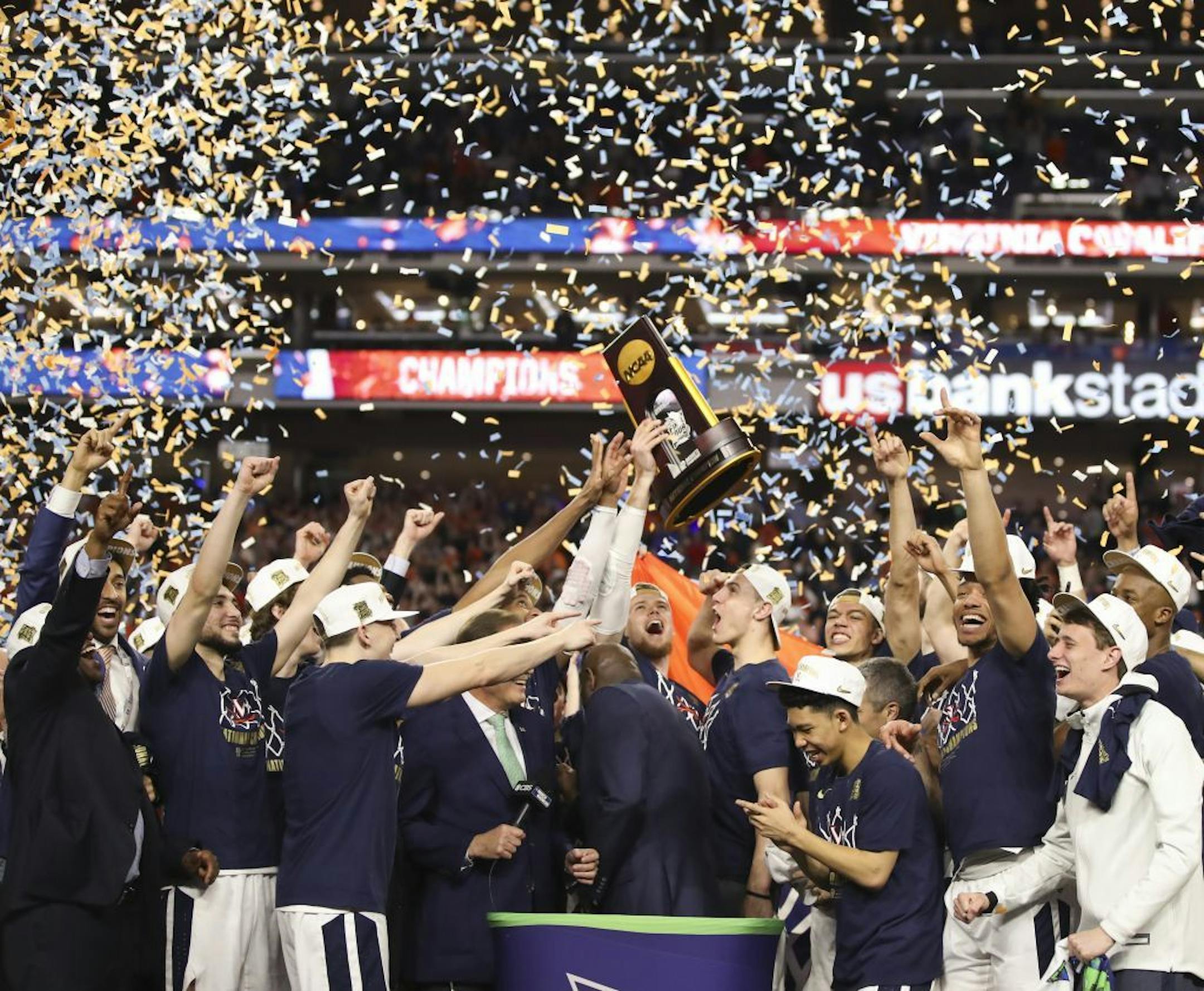 The Cavaliers held the championship trophy aloft after the presentation.