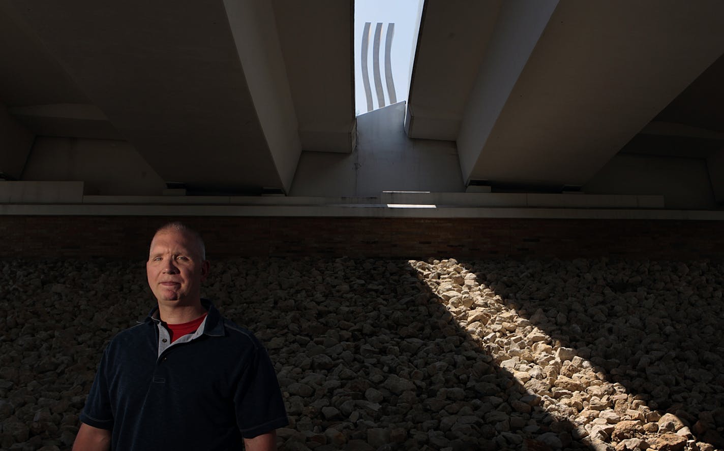 Garrett Ebling is one of survivors of the 35W bridge collapse. Ebling, a former journalist, wrote a book called "Collapsed" and now owns a sandwich franchise. Ebling was photographed beneath the new 35W bridge, where one of the Gateway Monuments atop the bridge loomed in the sunlight behind him.