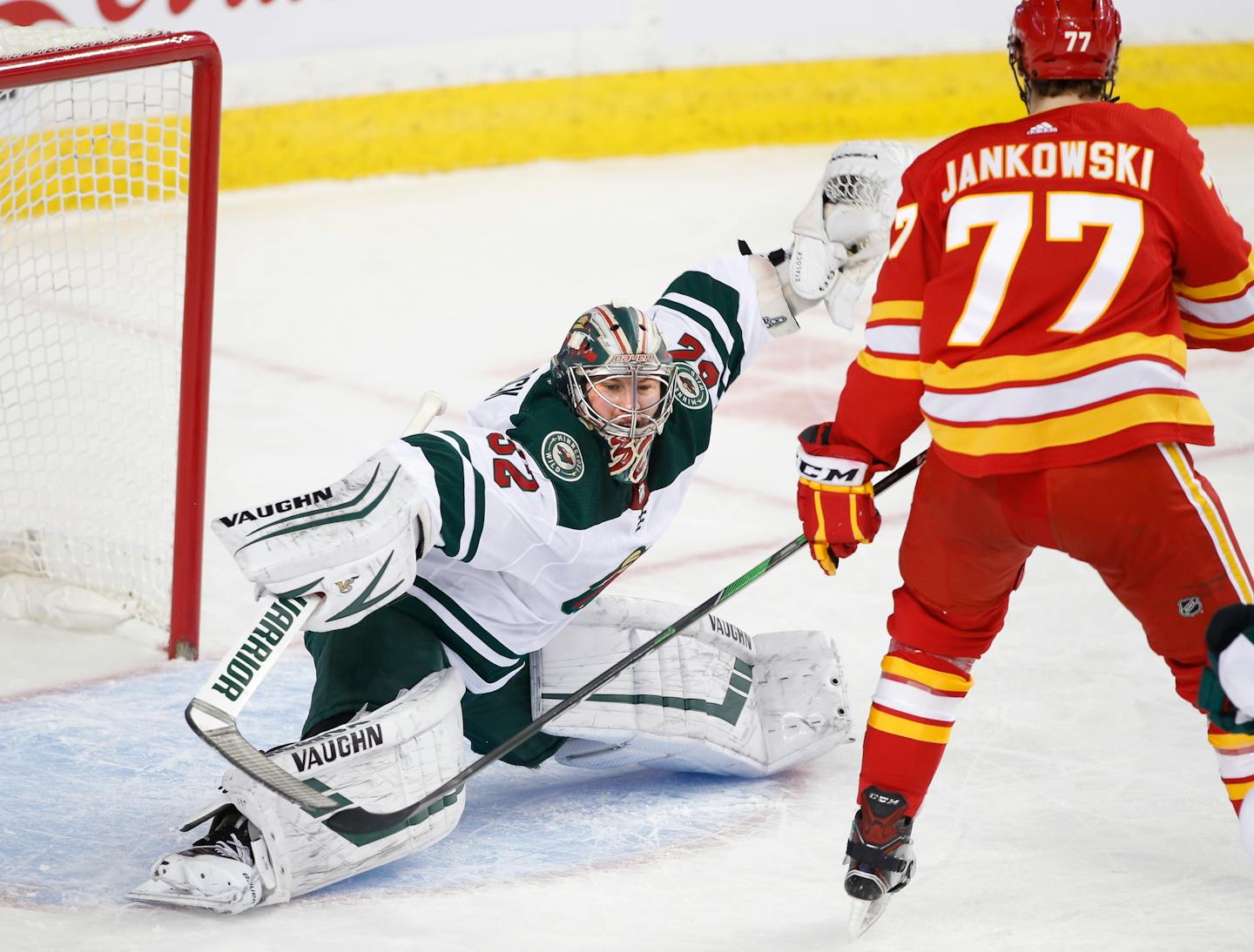 Wild goaltender Alex Stalock makes a save against Calgary centre Mark Jankowski during the first period