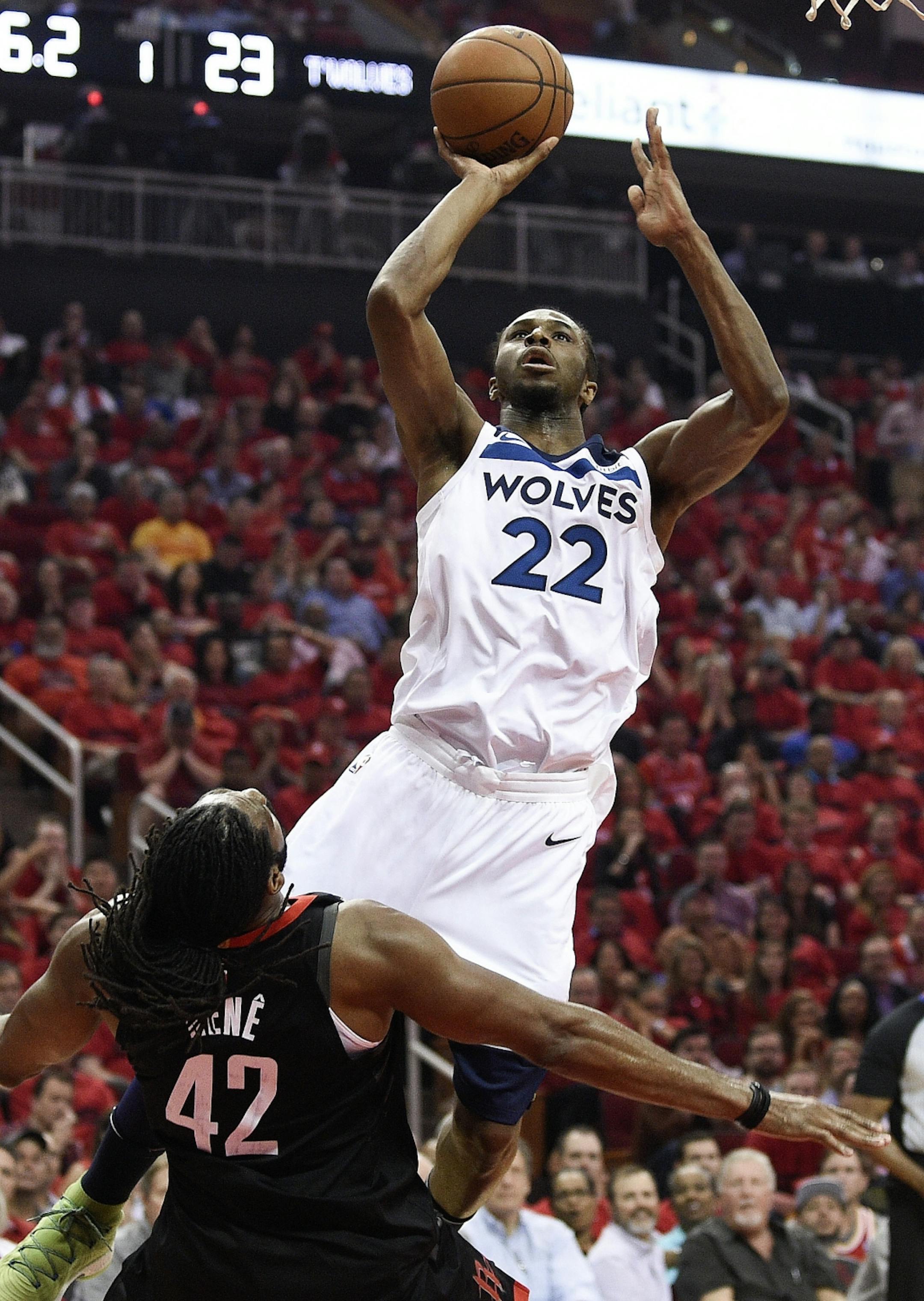 Minnesota Timberwolves forward Andrew Wiggins (22) drives to the basket and draws a foul from Houston Rockets center Nene Hilario during the first half in Game 5 of a first-round NBA basketball playoff series, Wednesday, April 25, 2018, in Houston.