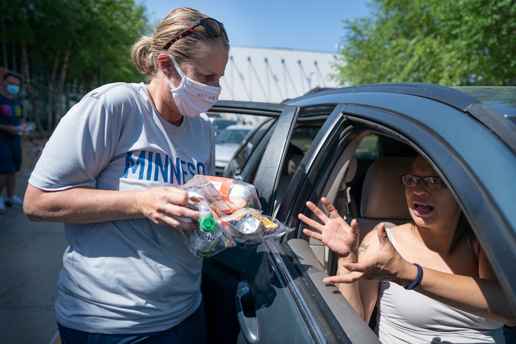 In June, Lynx coach Cheryl Reeve gave out supplies to families affected by riots in south Minneapolis. 