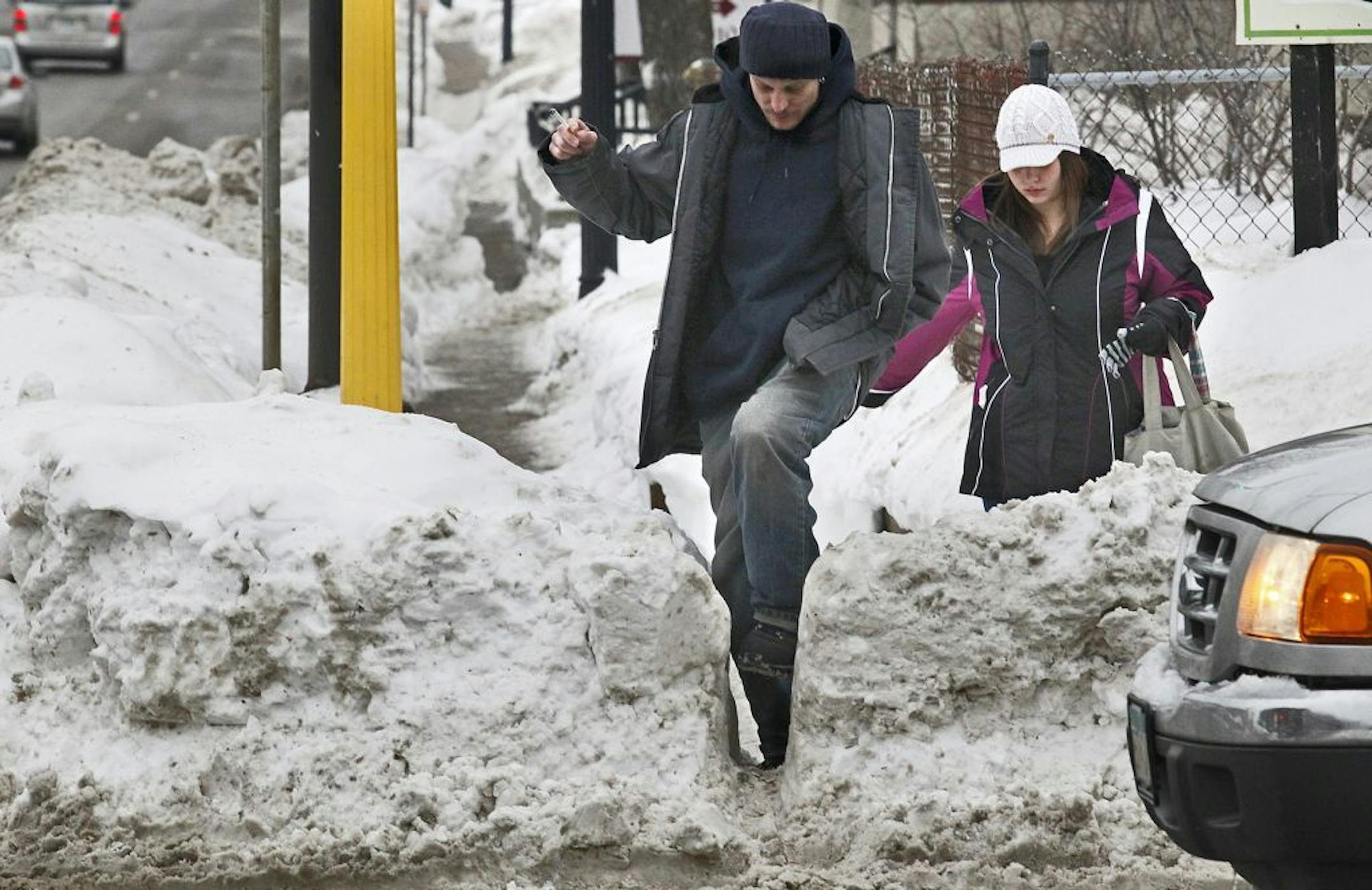 Scott Johnson, left, and Amy Smith made their way through snow piled up on street corners along Franklin Av. after a 2010 snowstorm.