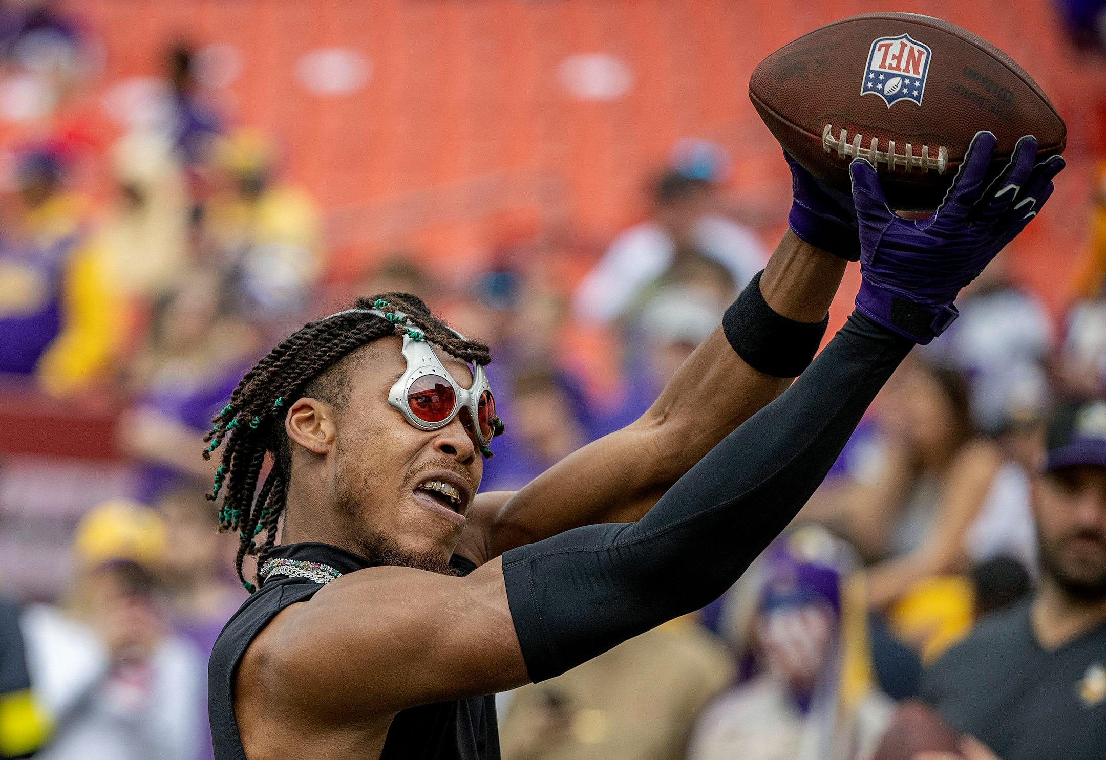 Wearing goggles, Minnesota Vikings wide receiver Justin Jefferson (18) warms up before they take on the Washington Commanders.