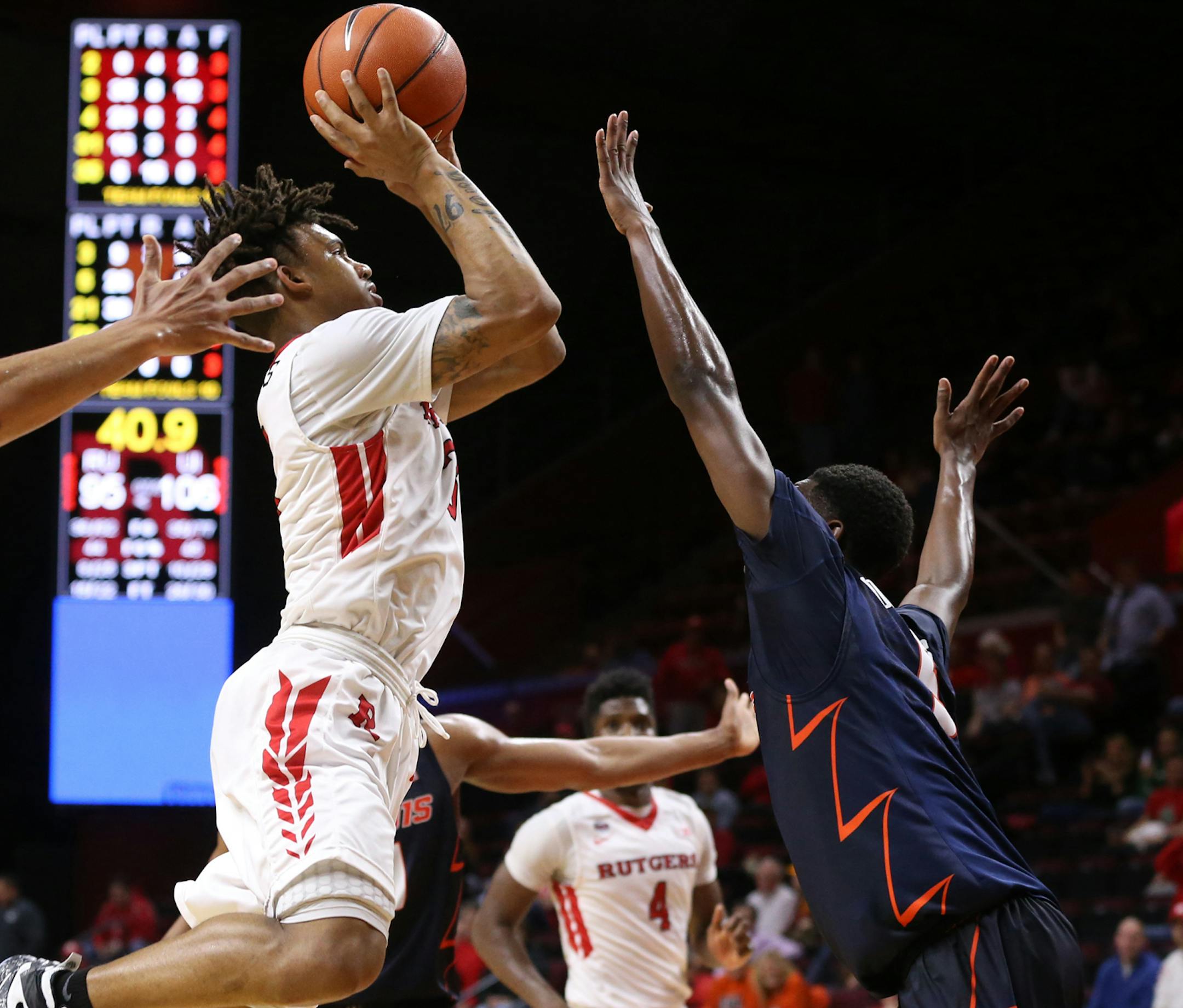 Rutgers' Corey Sanders shoots against Illinois, including Khalid Lewis, left, during an NCAA college basketball game Wednesday, Feb. 3, 2016, in Piscataway, N.J. (Jason Towlen/The Asbury Park Press via AP)